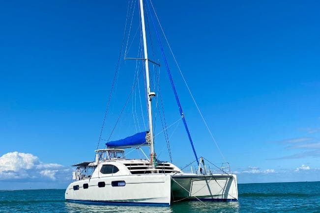 2007 Leopard 46 catamaran sailing on calm blue waters under clear skies.