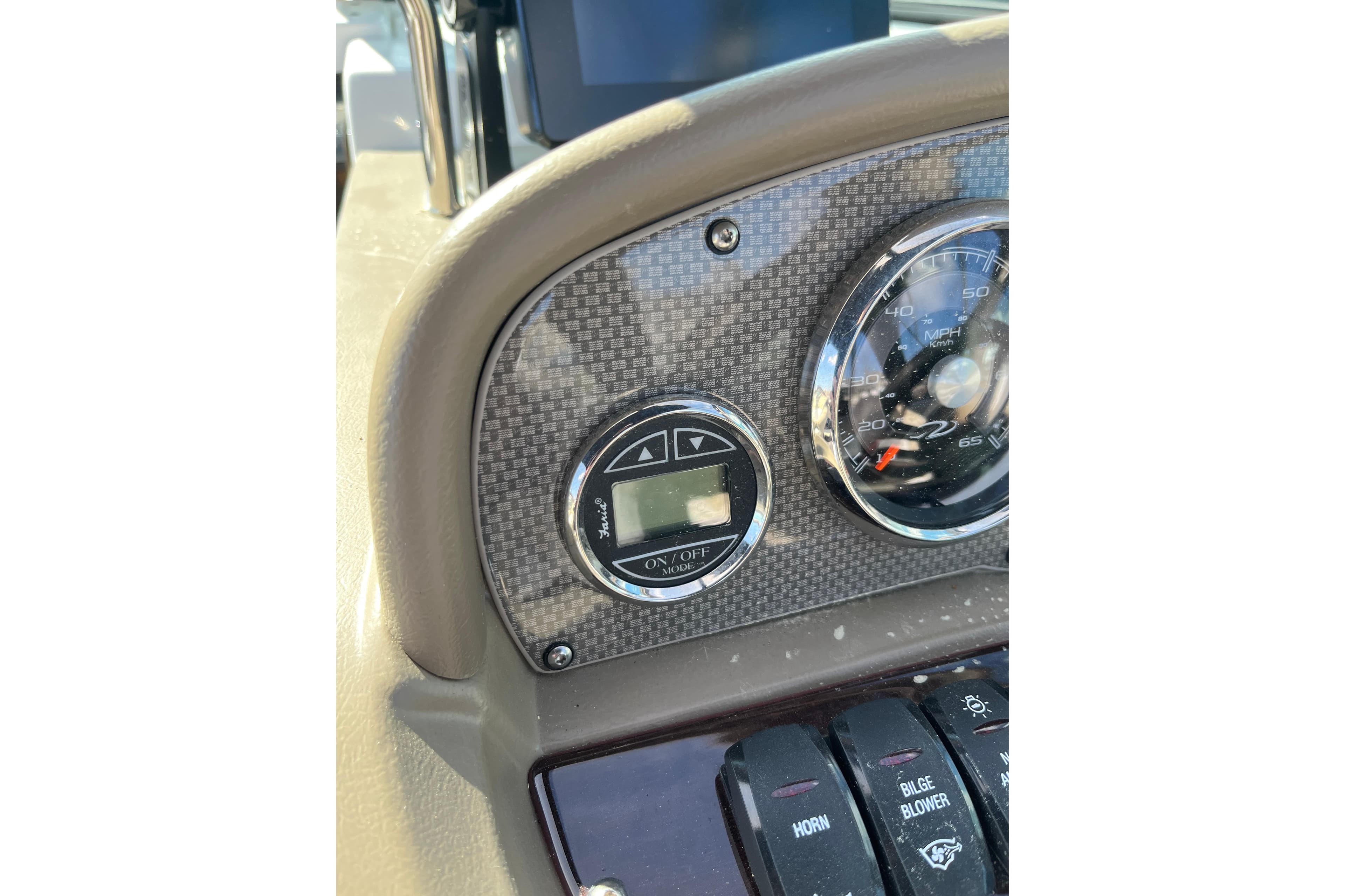 Dashboard of a 2015 Regal 2250 Cuddy boat with speedometer and controls.
