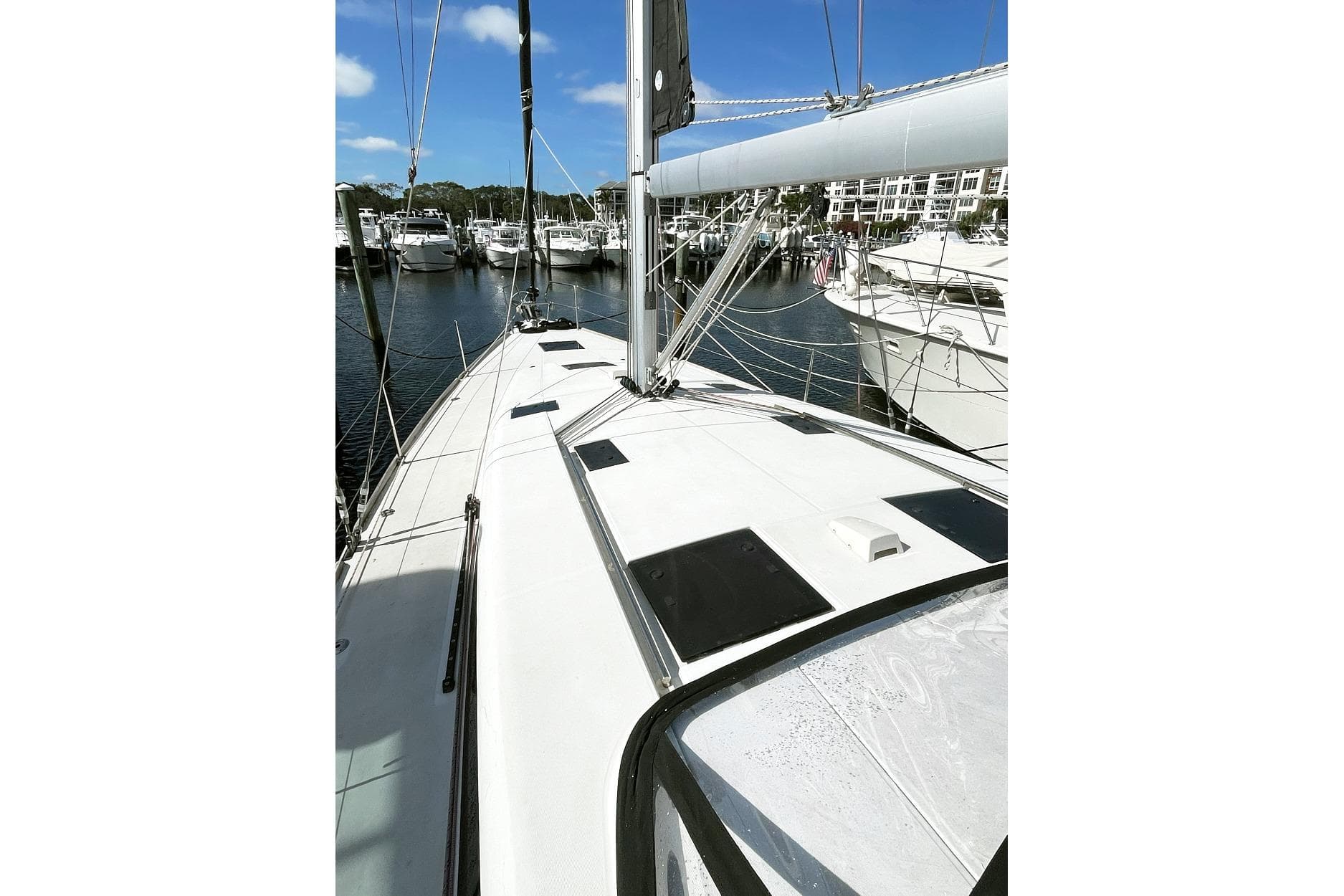 2013 Beneteau Sense 46 sailboat deck view in marina, showcasing sleek design and rigging.