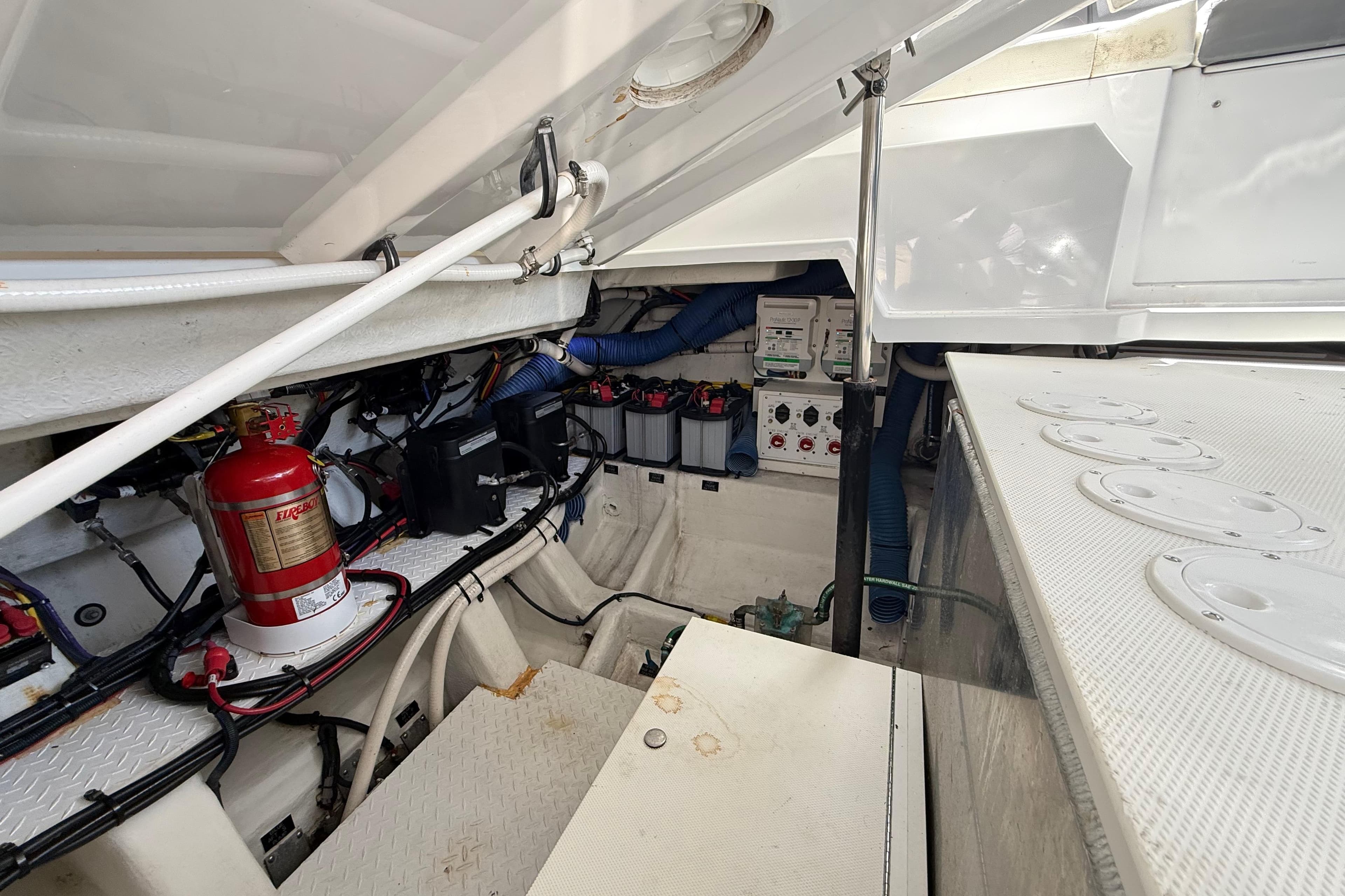 Engine compartment of 2021 Cruisers Yachts 38 GLS OB, featuring wiring and fire extinguisher.