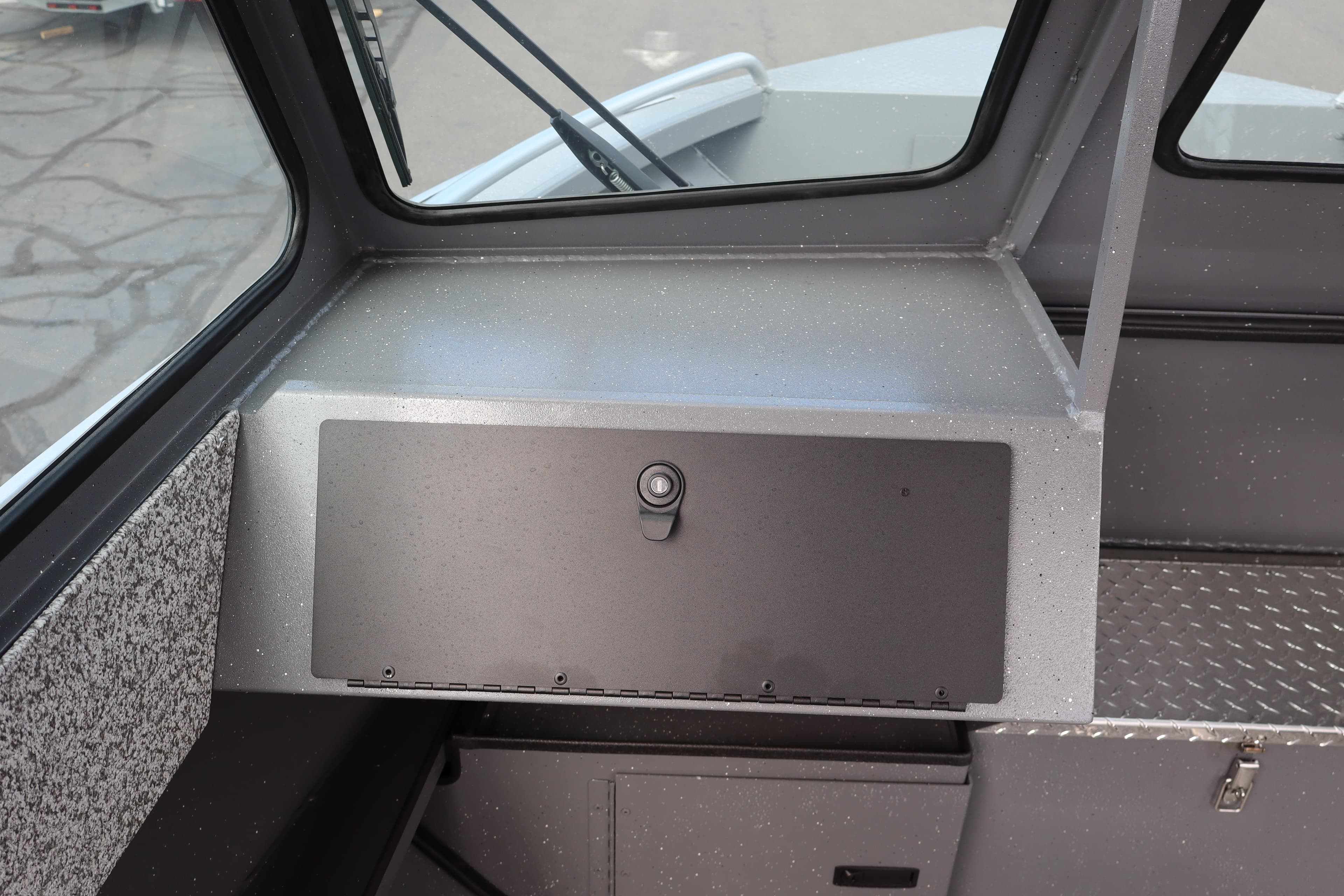 2026 Alumaweld Intruder Outboard 20 dashboard with storage compartment and window view.