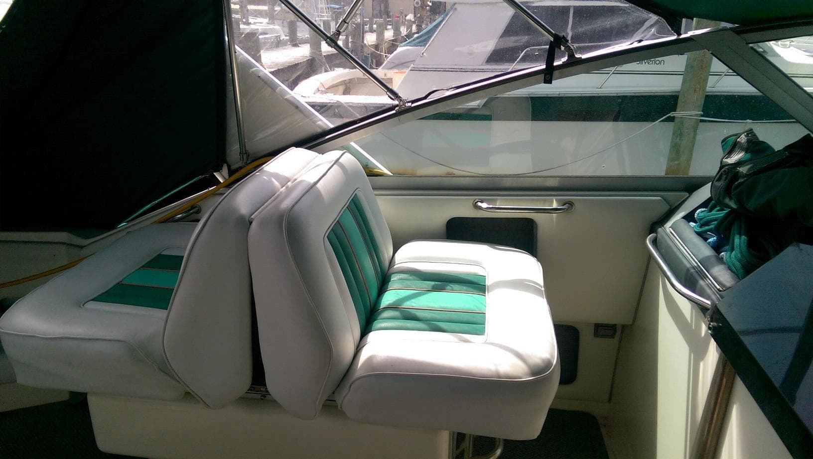 Interior of 1993 Sea Ray 330 Express Cruiser with green and white seating.