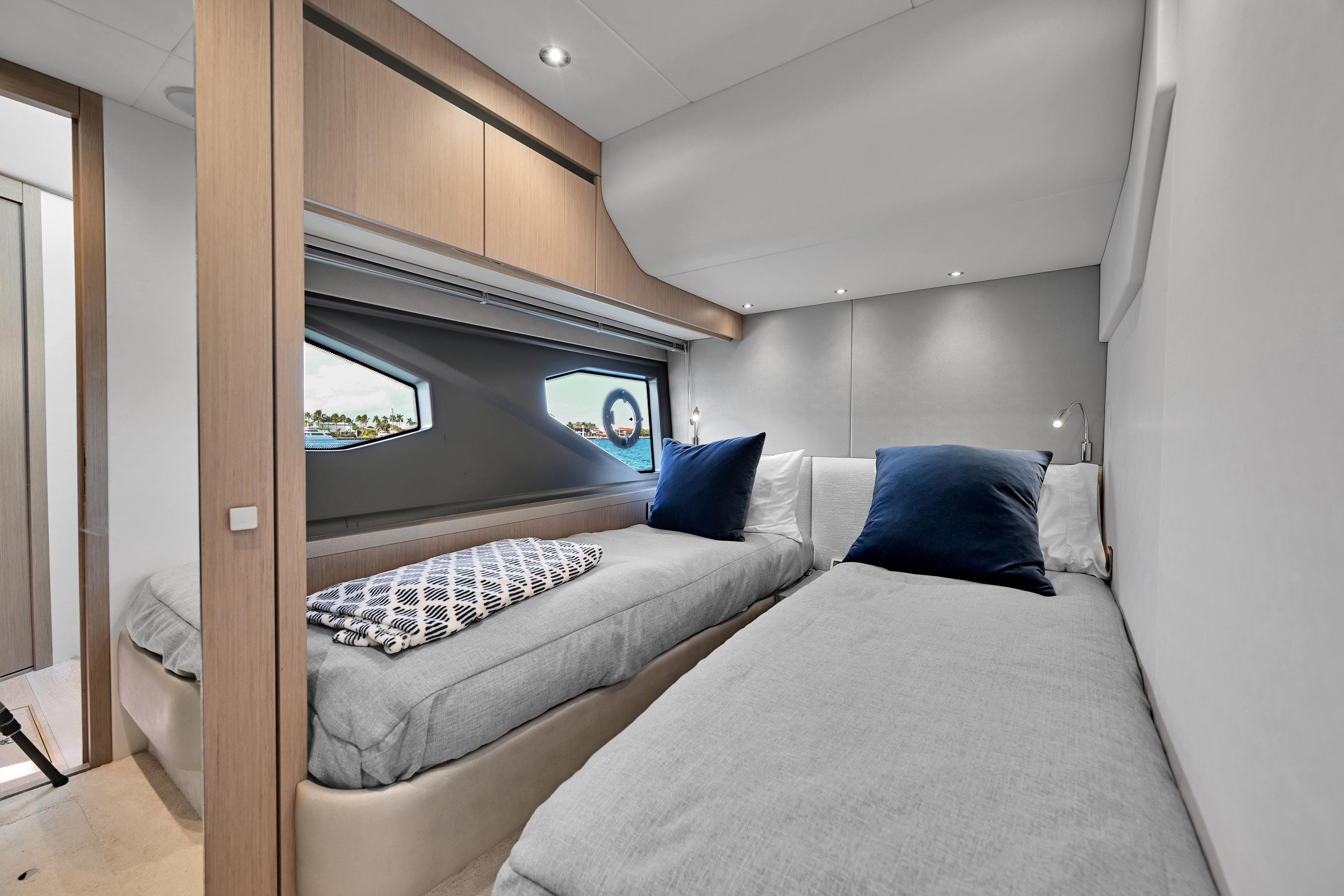 Luxurious cabin interior of 2020 Sunseeker Manhattan 52 yacht with twin beds and modern decor.