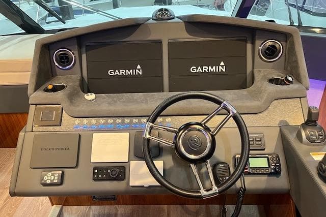 2023 Riviera 5400 Sport Yacht helm with Garmin displays and Volvo Penta controls.