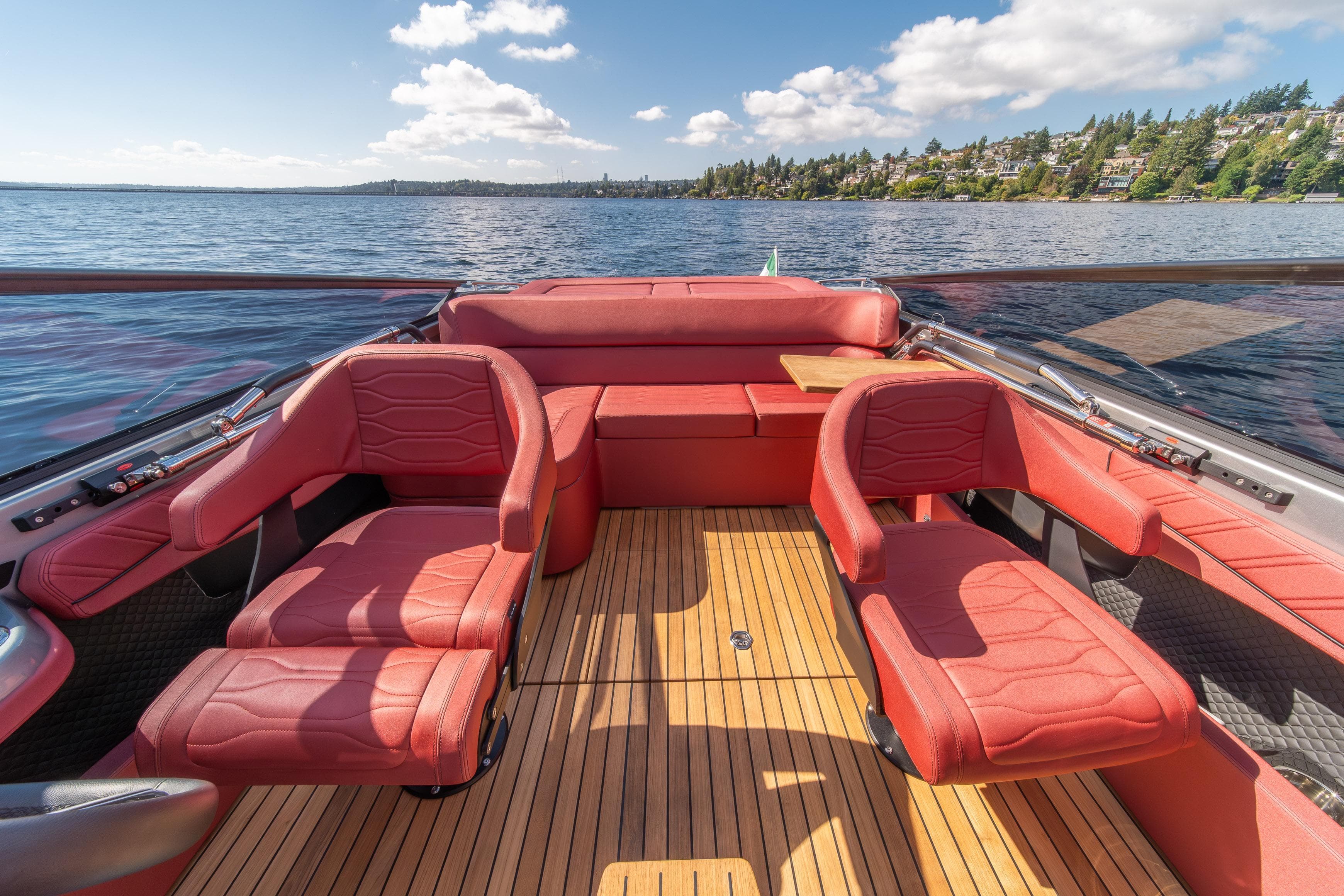 Luxurious 2026 Cranchi E26 Classic boat interior with red leather seats and wooden deck.