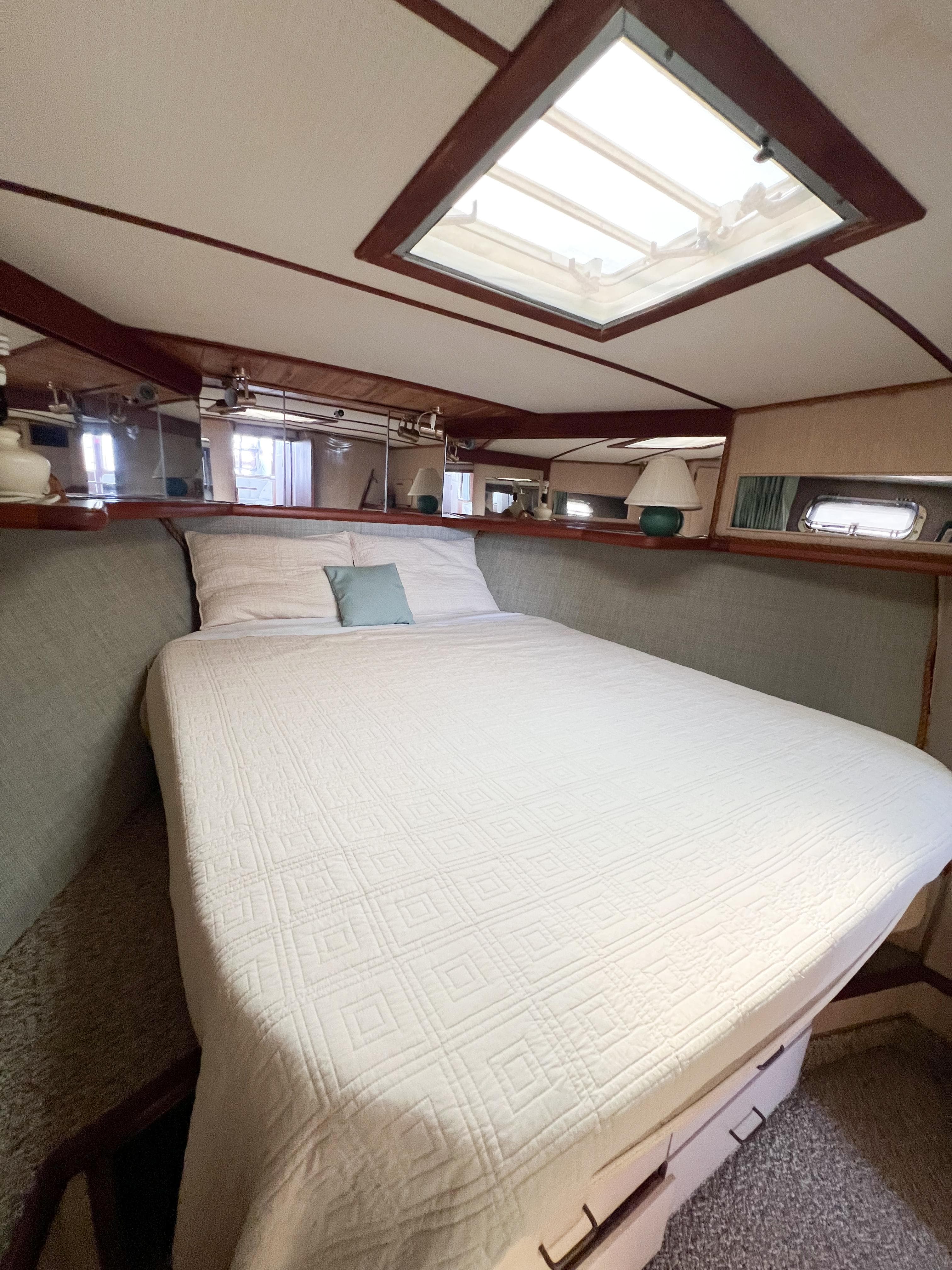 1987 Tollycraft 34 Sport Sedan cabin with bed, skylight, and cozy interior.