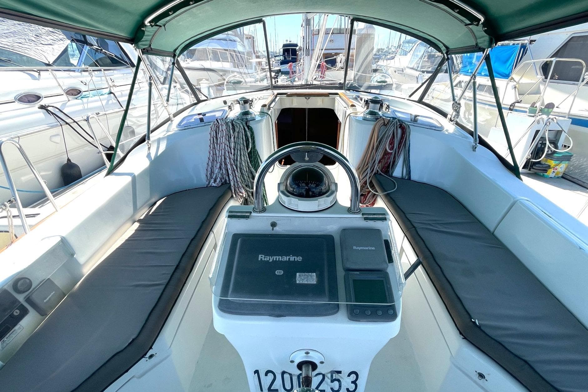Cockpit of 2007 Beneteau 423 sailboat with Raymarine navigation system and seating.