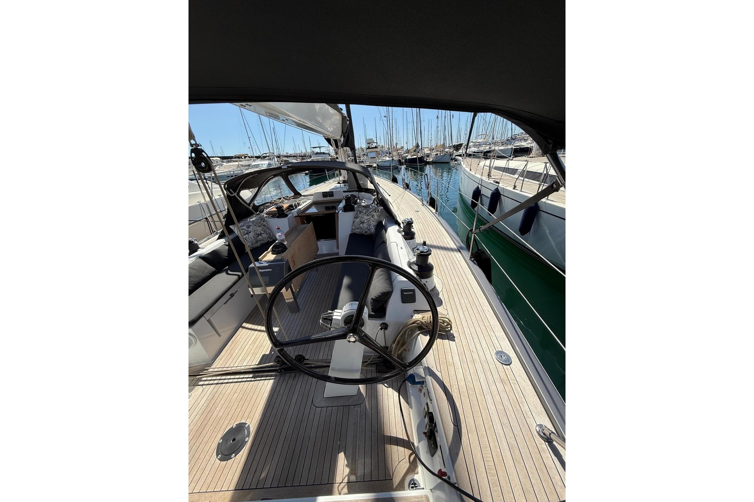2012 Solaris 48 yacht interior with dual steering wheels and wooden deck in marina.