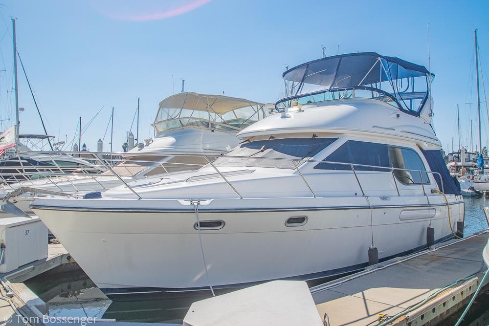 2001 Bayliner 3788 Command Bridge Motoryacht docked at marina under clear sky.