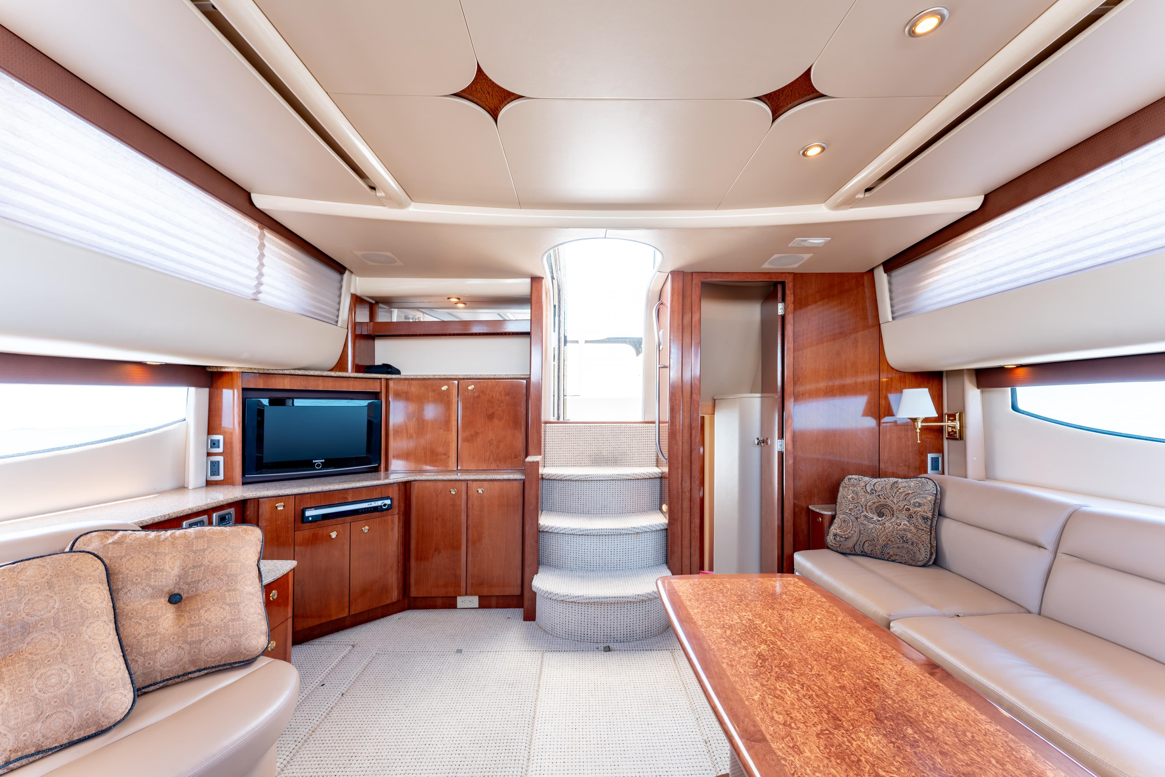 Luxurious interior of 2008 Meridian 459 Motoryacht with elegant wood finishes and plush seating.