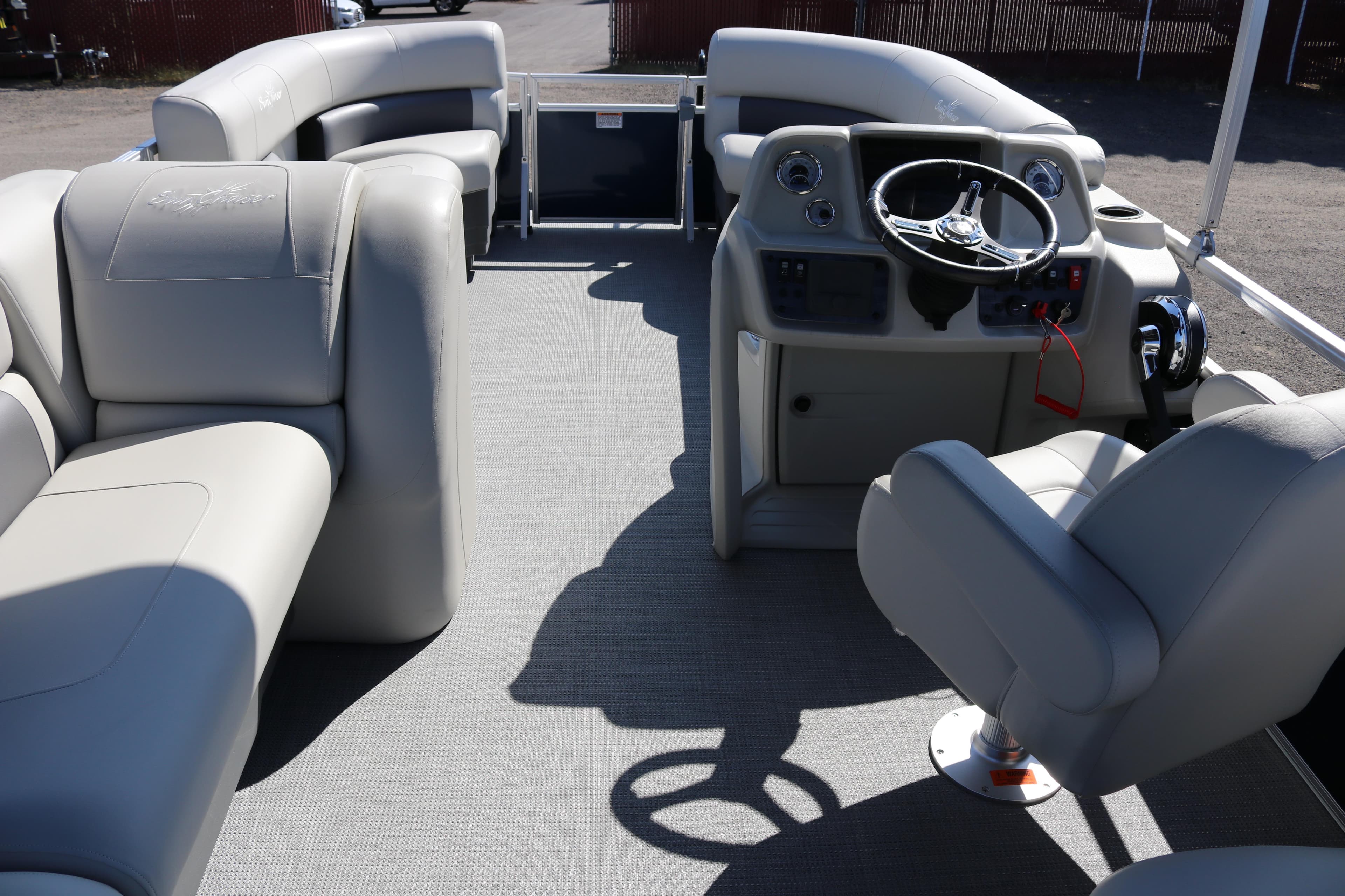 Interior of 2025 SunChaser Vista 18 LR pontoon boat with plush seating and steering console.