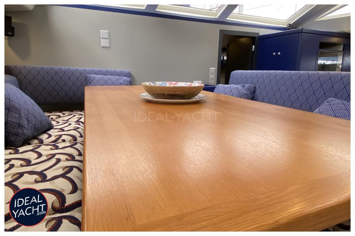 Interior of 2008 Garcia 65ft Aluminium Centerboard yacht with wooden table and patterned seating.