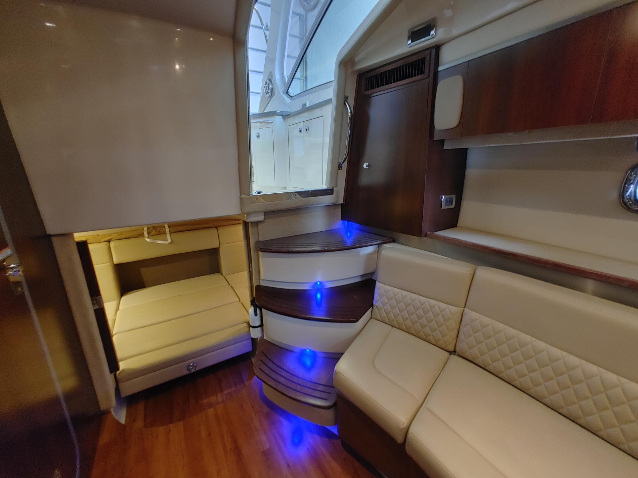 Luxurious interior of 2013 Chaparral 330 Signature yacht with elegant seating and ambient lighting.