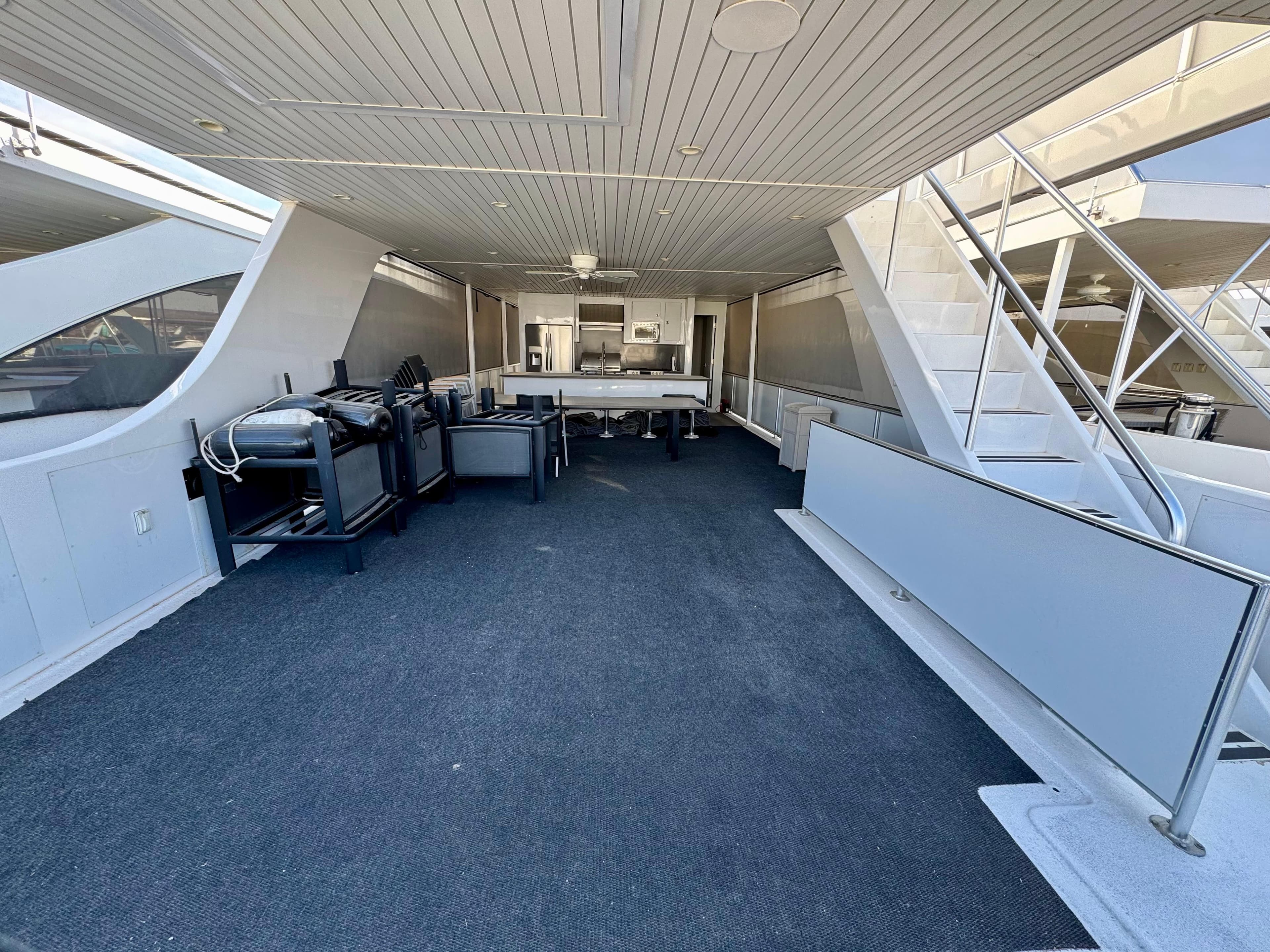 Spacious deck area on Adonia Just Add Water Trip #13, featuring grills and seating, 2021 model.