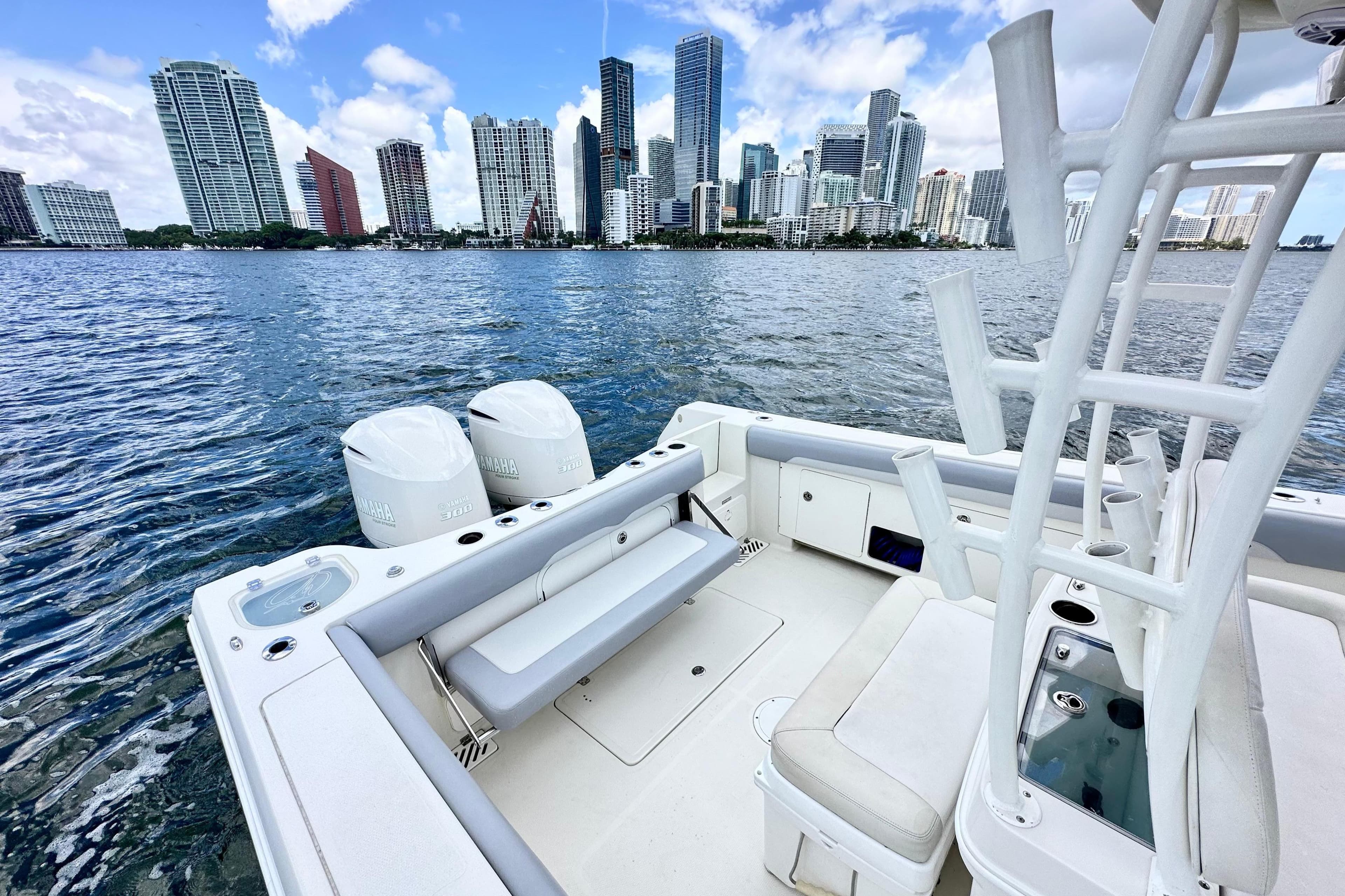 2014 Sailfish 320 CC boat with city skyline in the background.