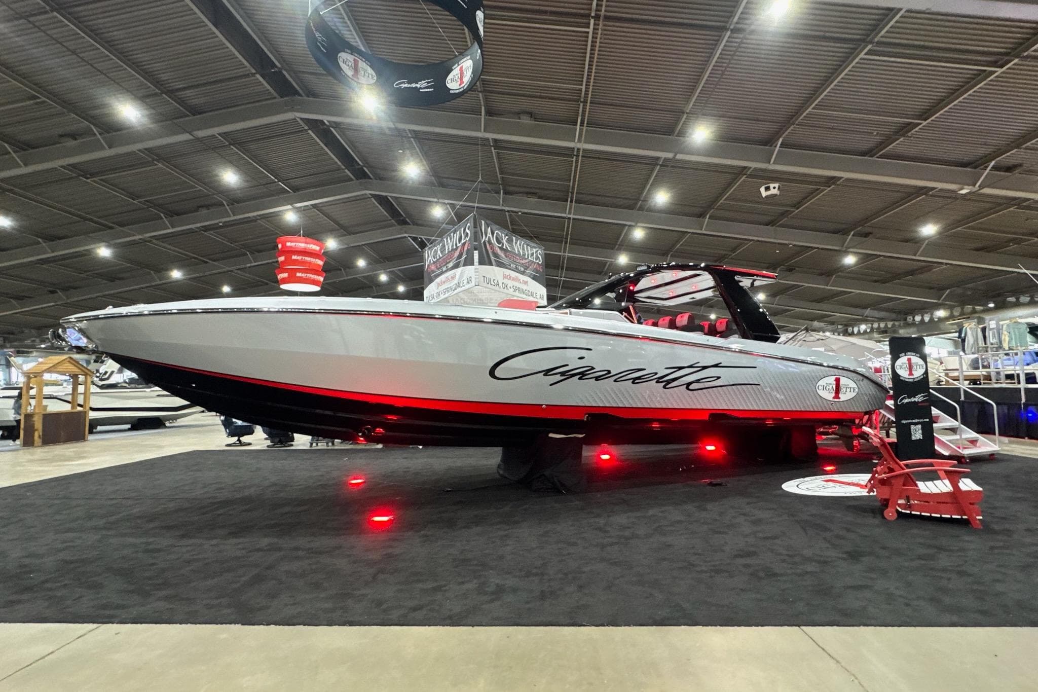 2024 Cigarette 41' Nighthawk SD Edition boat displayed indoors with red lighting.