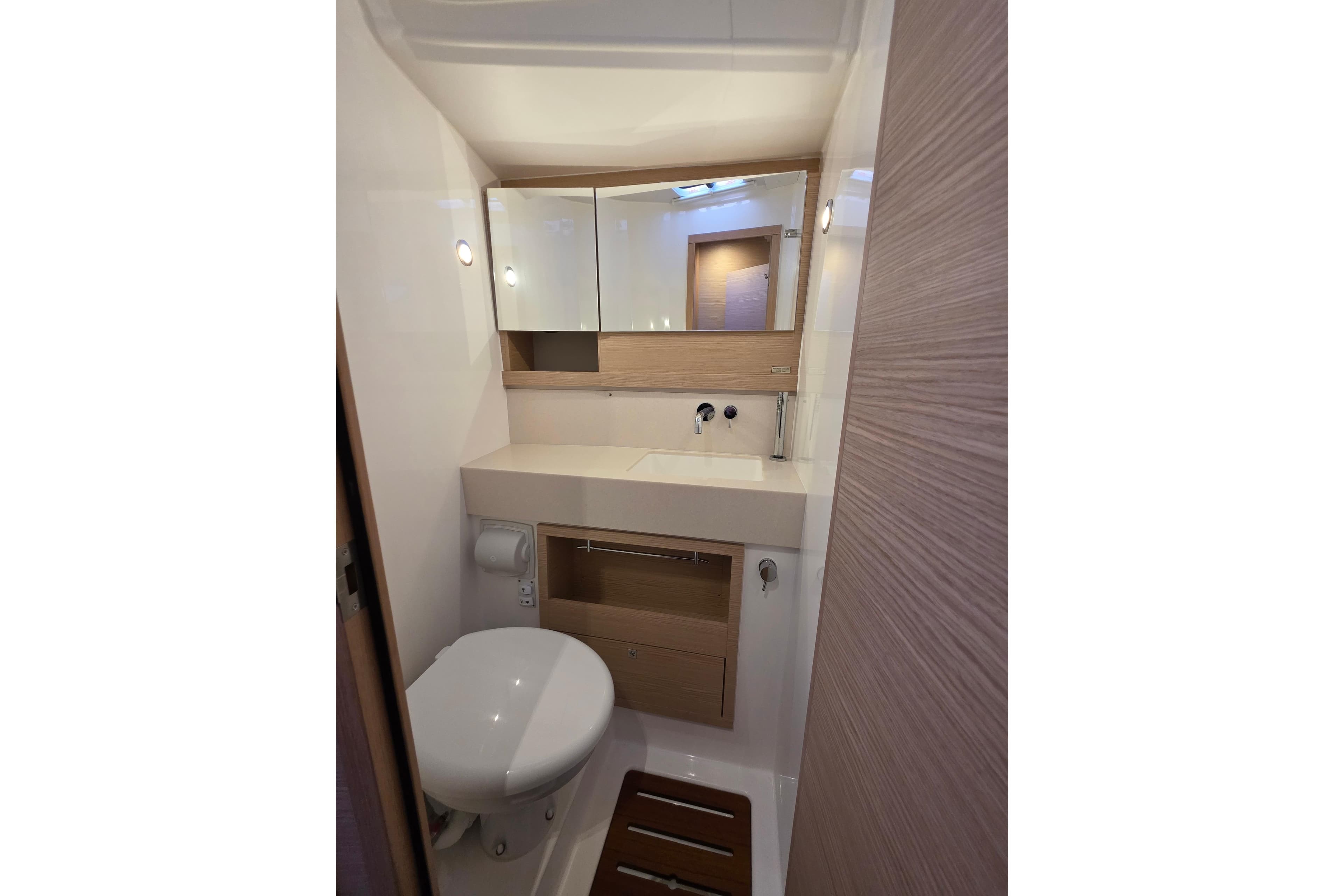 2024 Dufour 530 yacht bathroom with modern fixtures and wooden accents.
