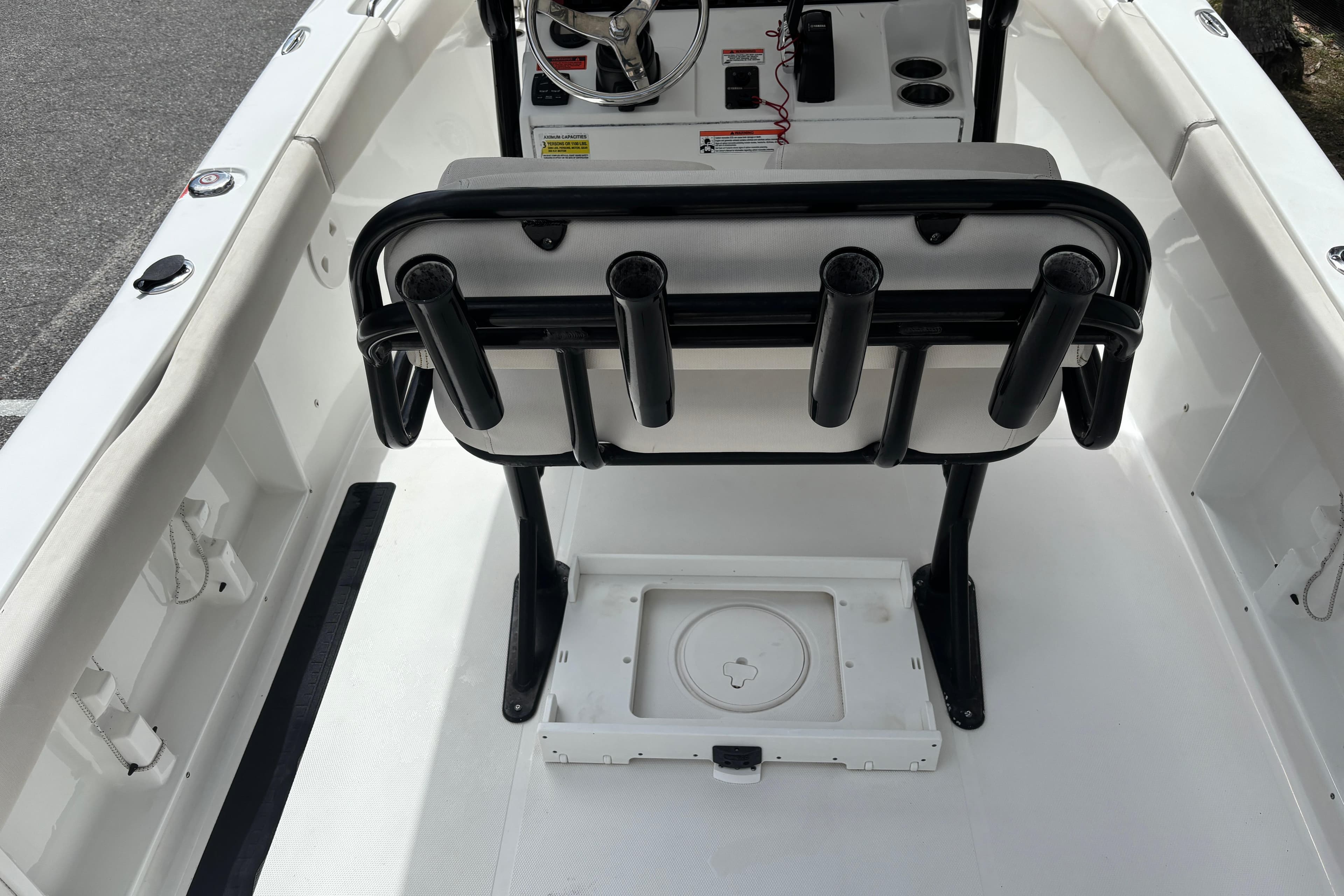 2021 Sea Hunt Ultra 219 boat interior with rod holders and steering console.