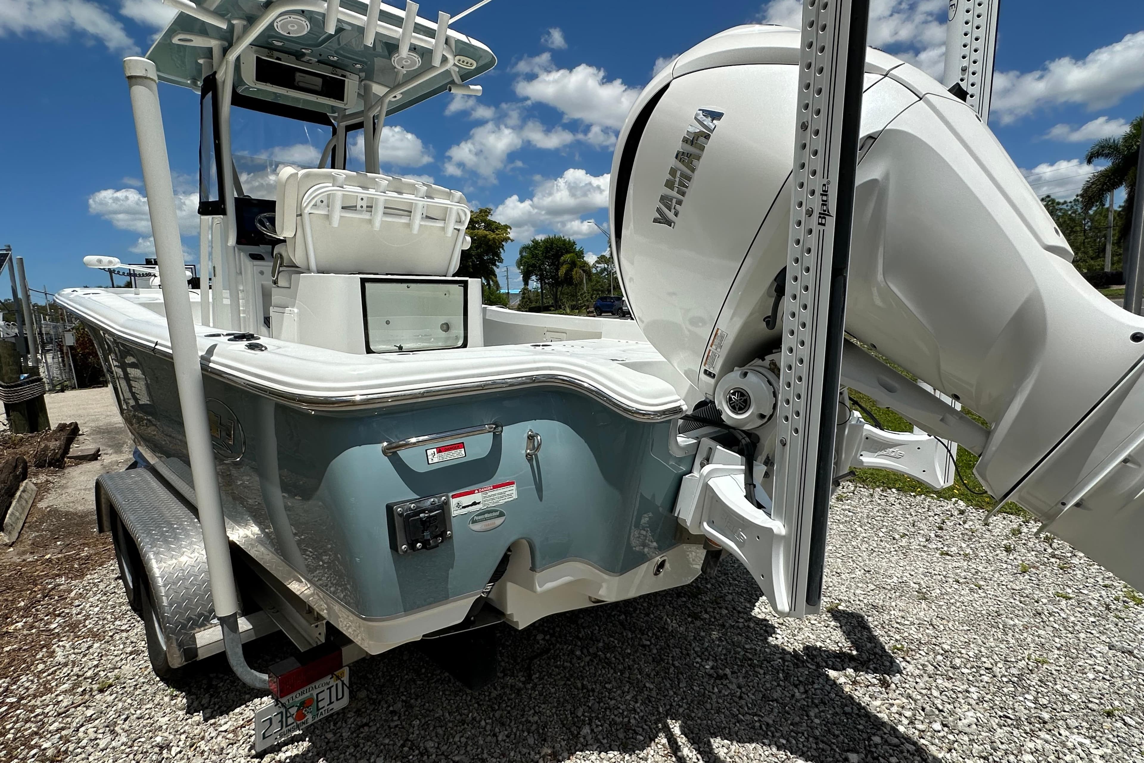 2023 Sea Hunt BX 25 BR boat with Yamaha engine on a trailer, under a sunny sky.
