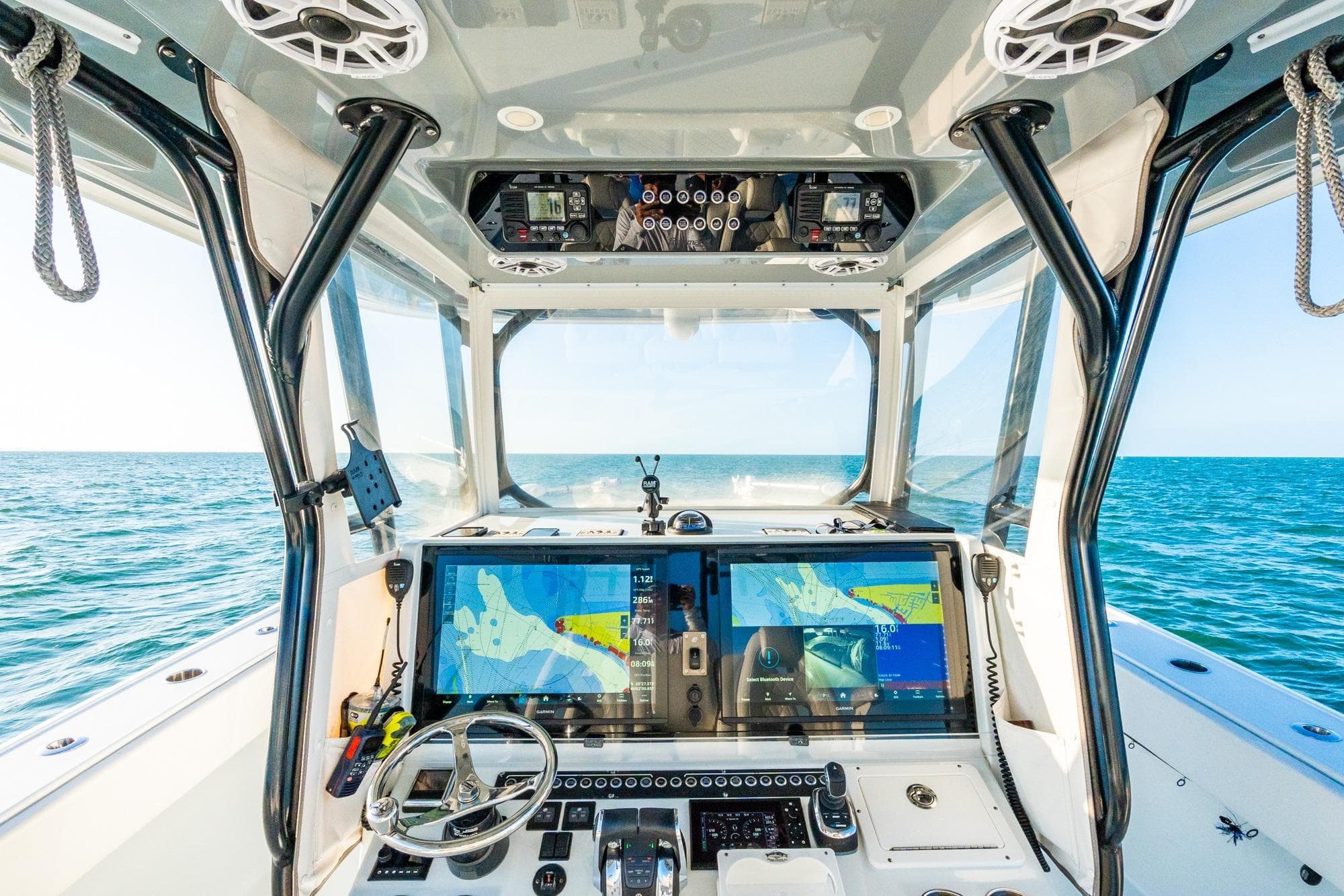 Cockpit view of 2022 Freeman 42LR boat with advanced navigation systems on open sea.