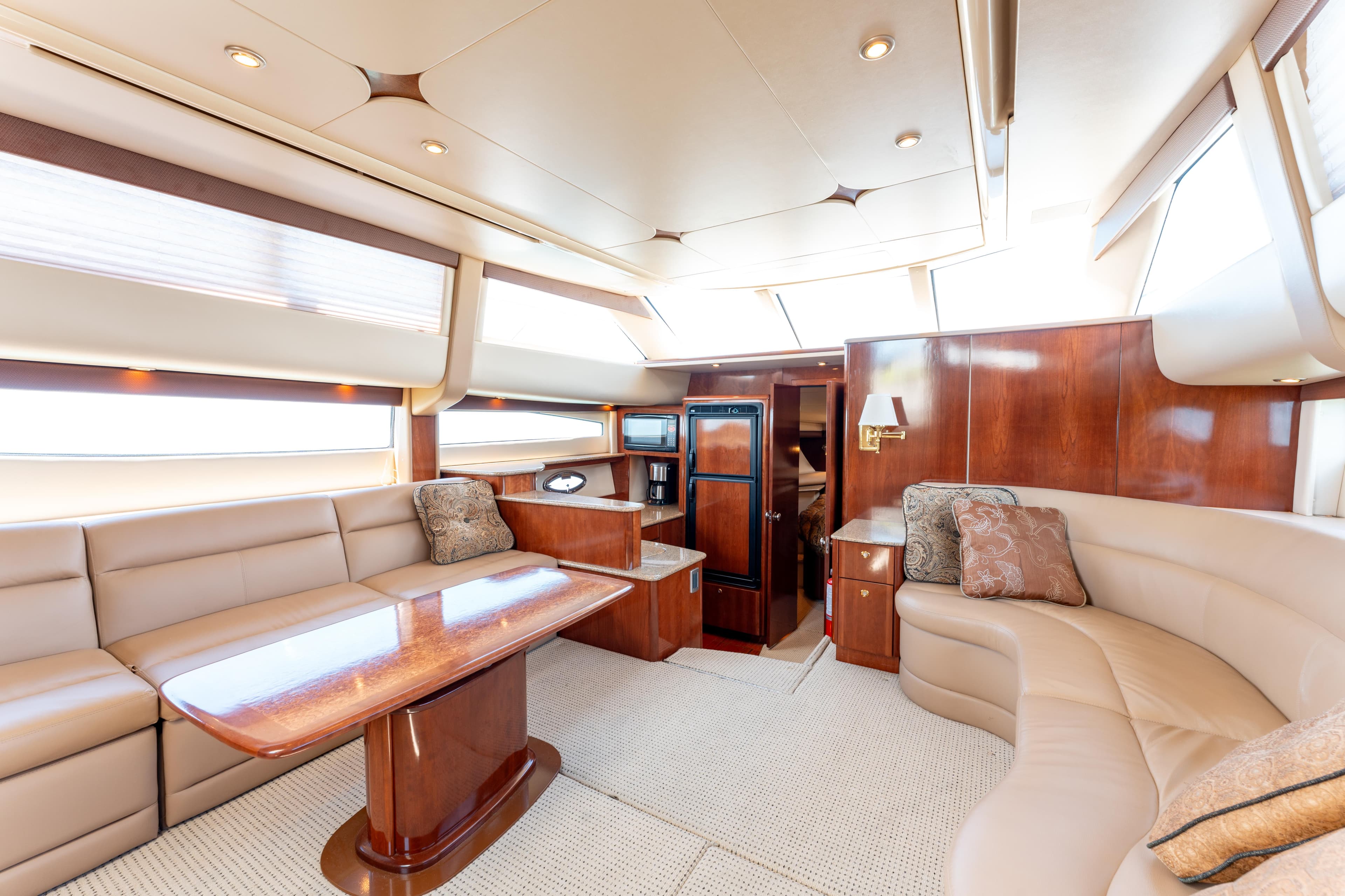 Luxurious interior of 2008 Meridian 459 Motoryacht with plush seating and elegant wood finishes.