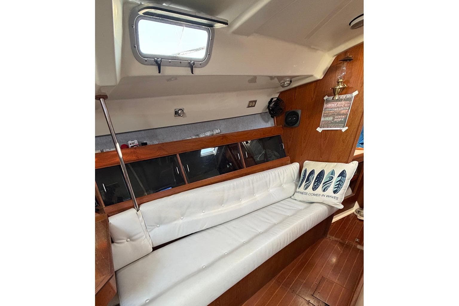 Interior of 1987 Hunter Marine LEGEND 40-1 sailboat with white seating and nautical decor.