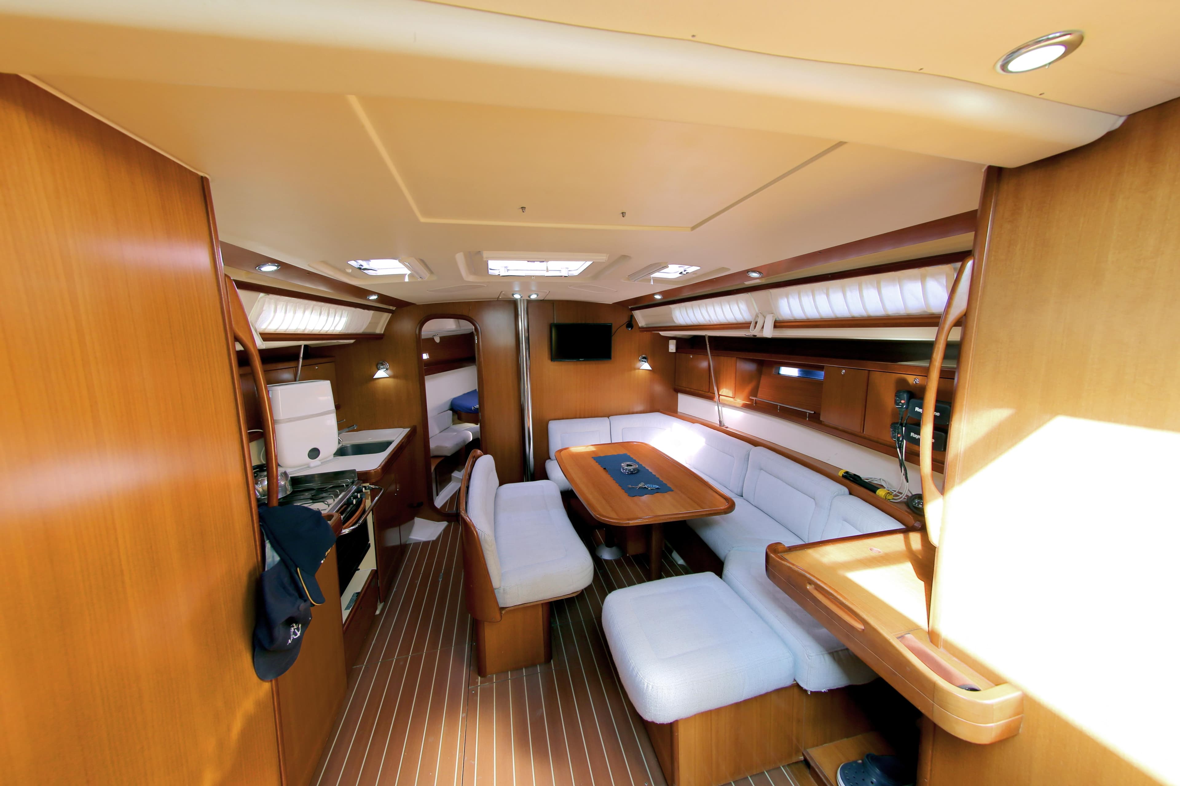Interior of 2007 Dufour 425 Grand Large yacht with wood finish and white seating.