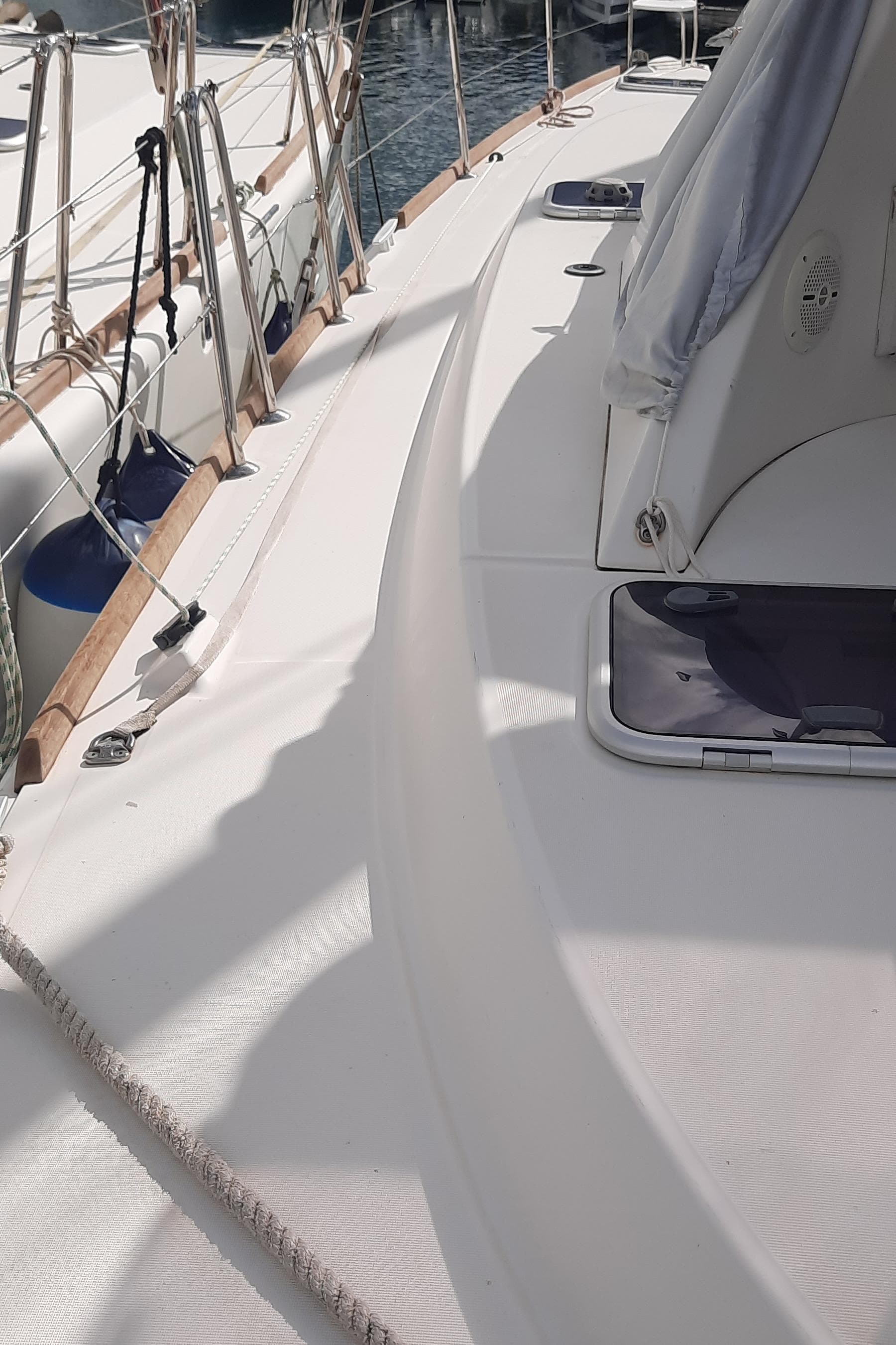 2018 Lagoon 380 catamaran deck with ropes and hatch, docked at marina.