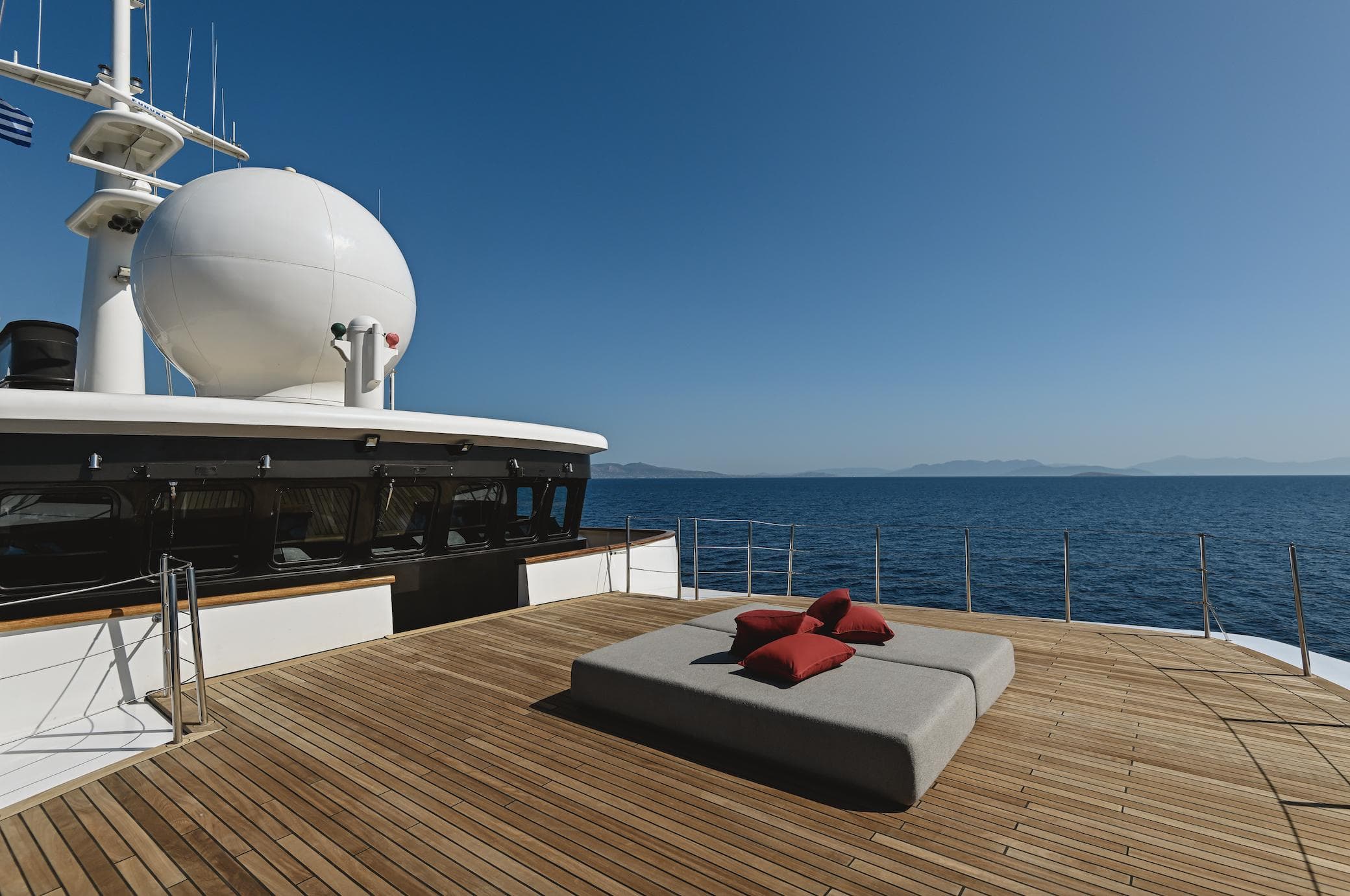 Luxurious Devonport 86m yacht deck with cushions, ocean view, clear blue sky, built in 1963.