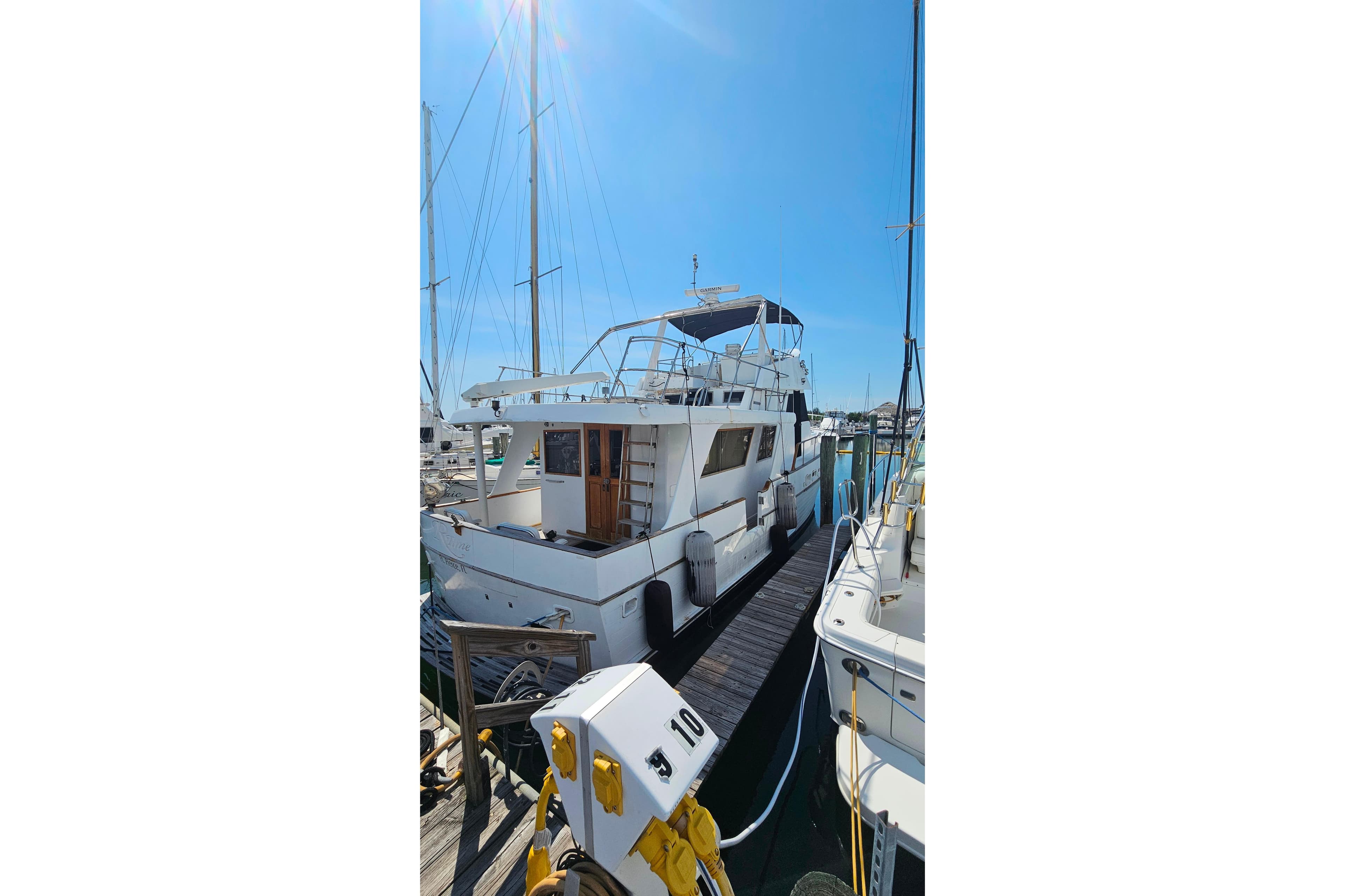 1981 Sea Ranger 47 Pilothouse yacht docked at marina under clear blue sky.