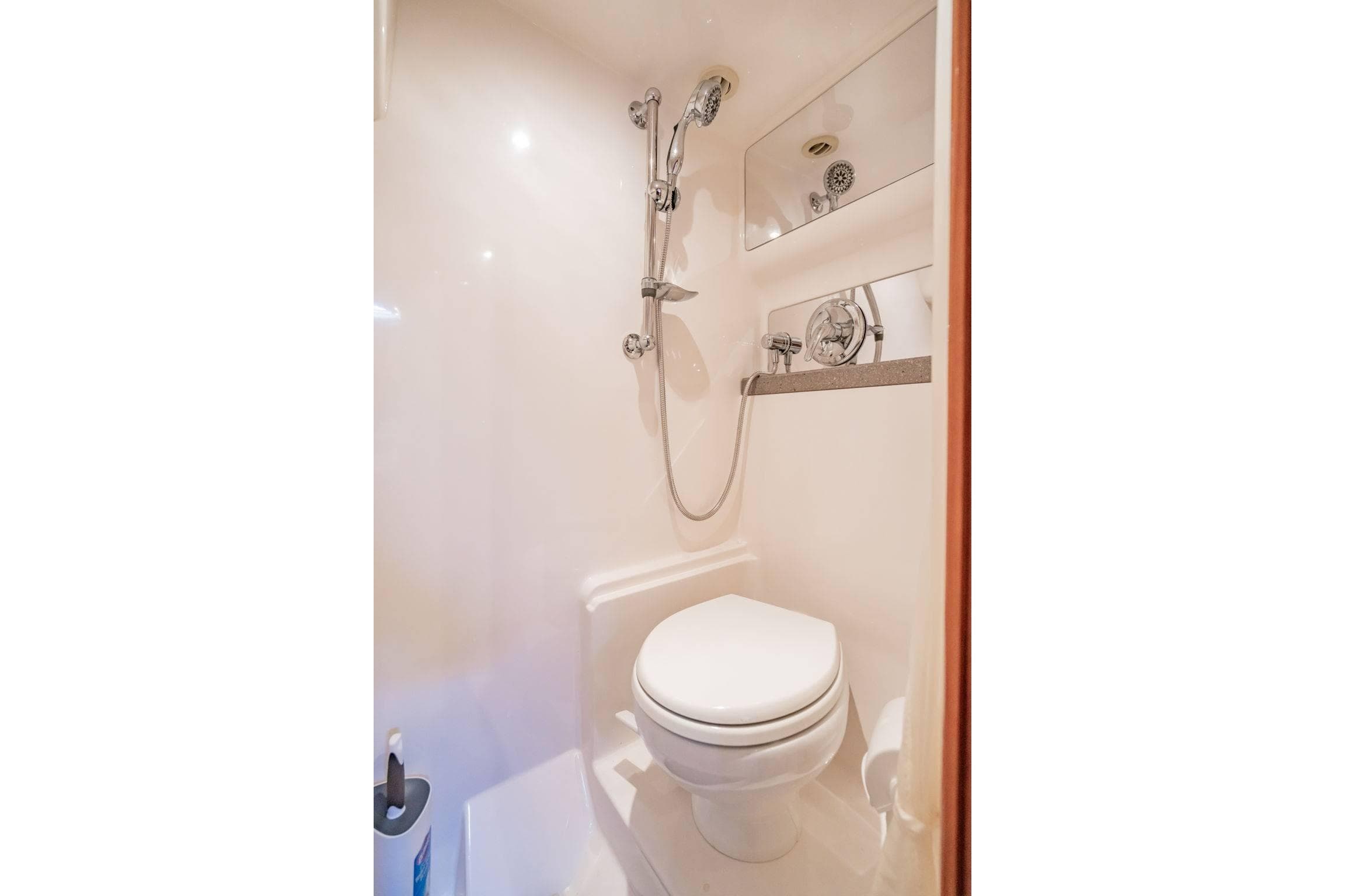 Compact bathroom in 2010 Regal Commodore 4460 yacht with shower and toilet.