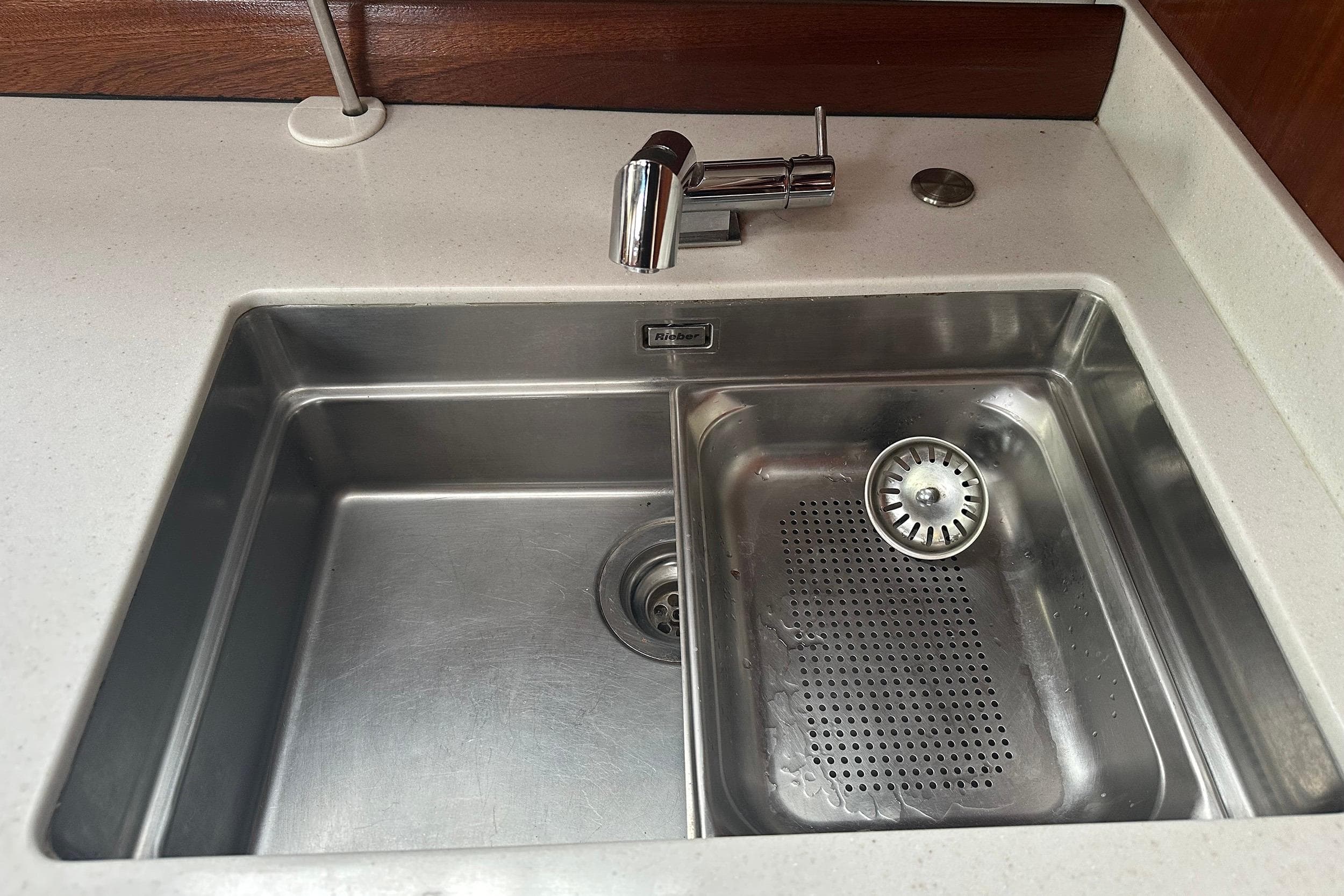 Stainless steel sink with modern faucet on Bavaria 44 yacht, 2003 model.