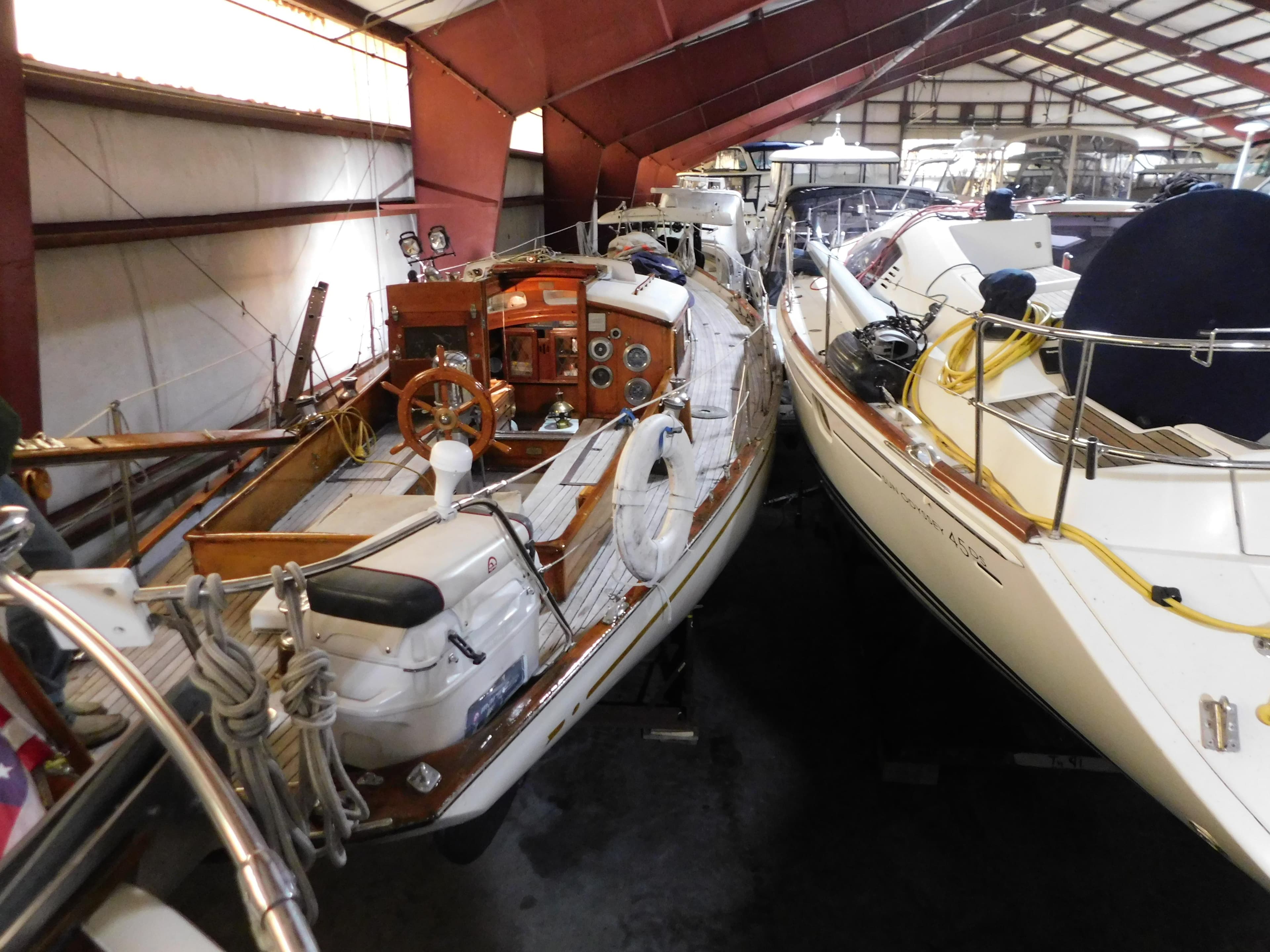 1949 Burger Full Keel Steel Auxiliary Ketch in indoor storage, alongside other boats.