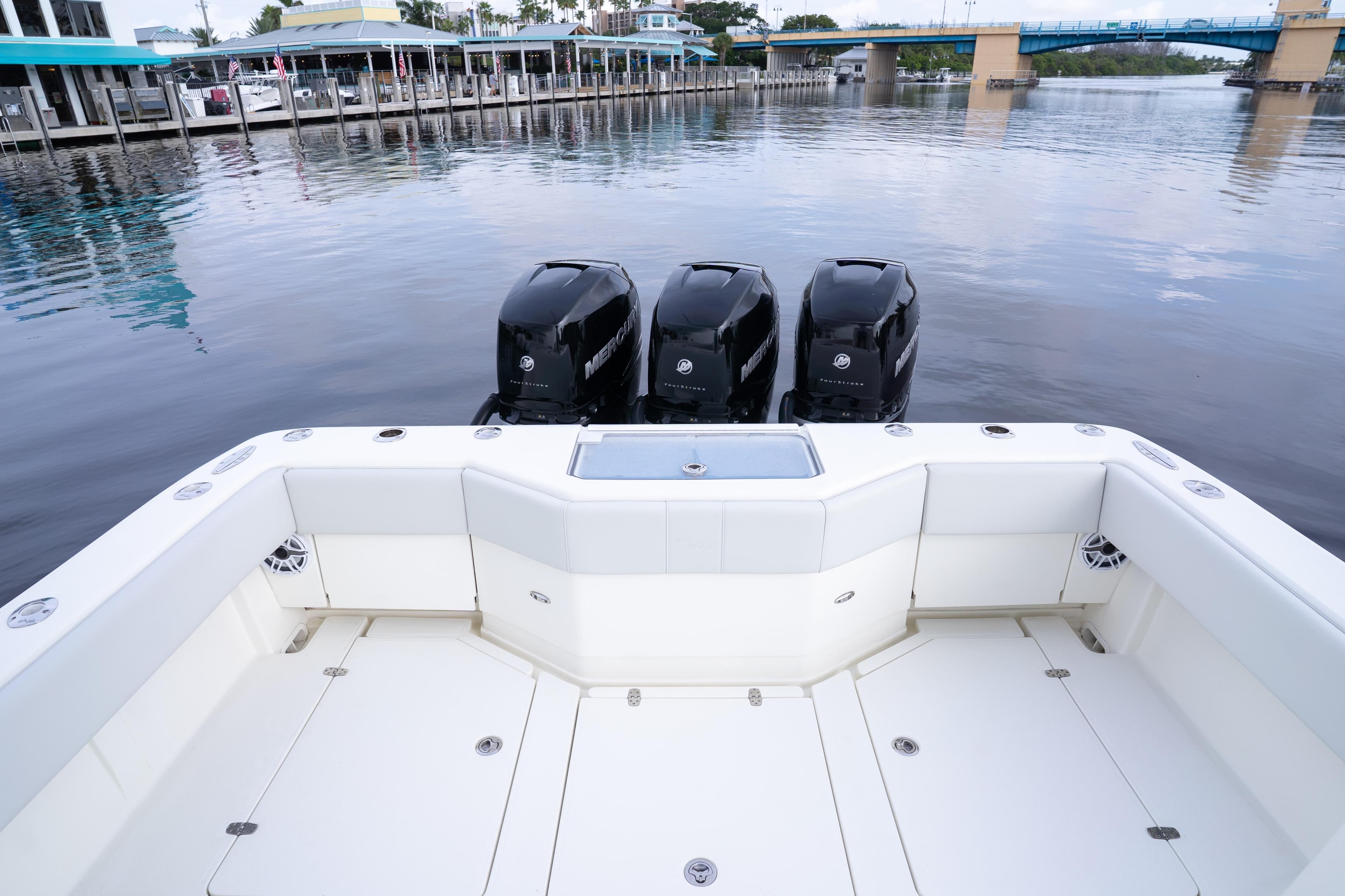 2015 SeaVee 39Z boat with triple Mercury engines, docked near a waterfront.