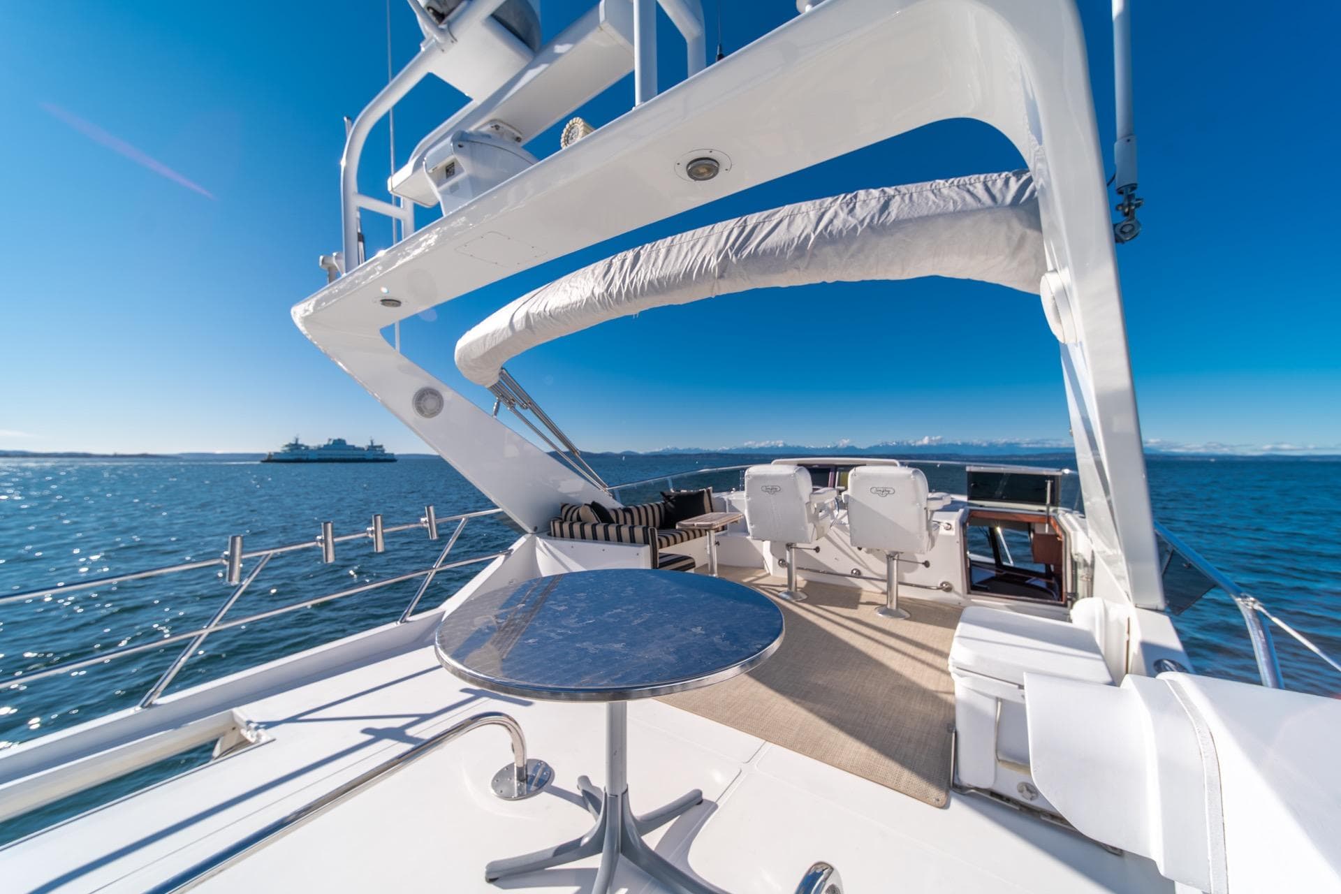 Luxurious 1998 West Bay 58 Sonship Pilothouse yacht deck with ocean view.