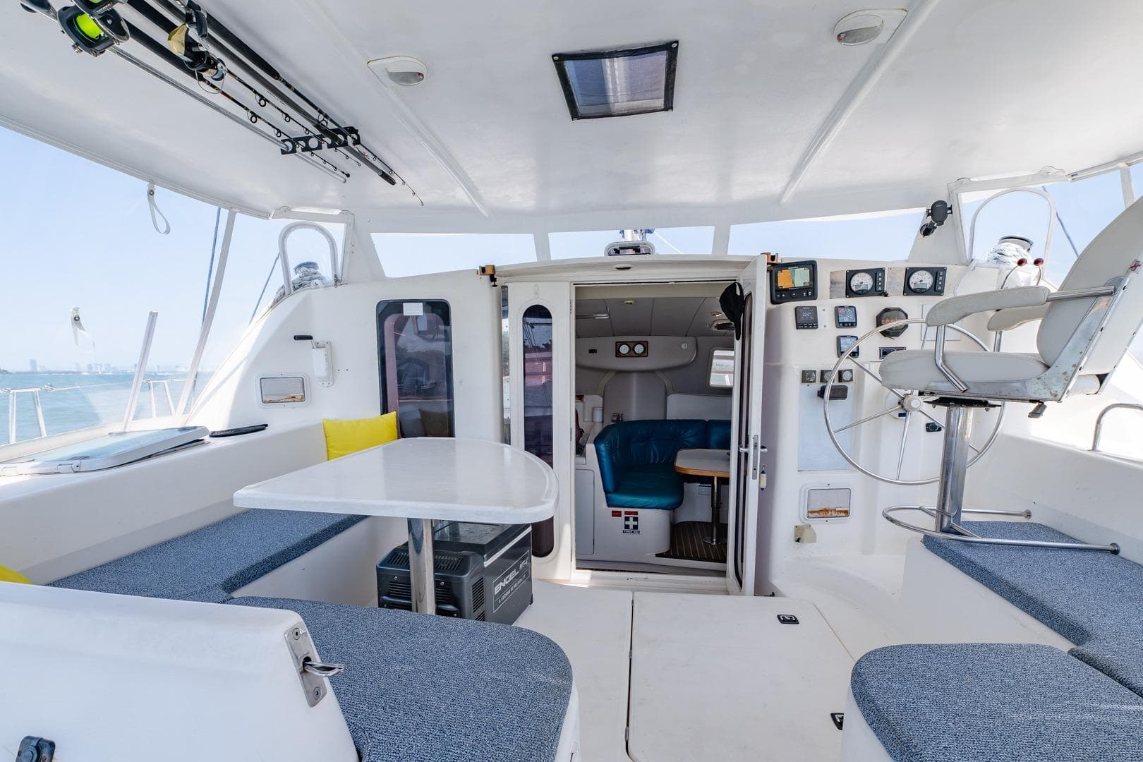 Interior of a 2000 Leopard 38 catamaran with seating, table, and helm station.