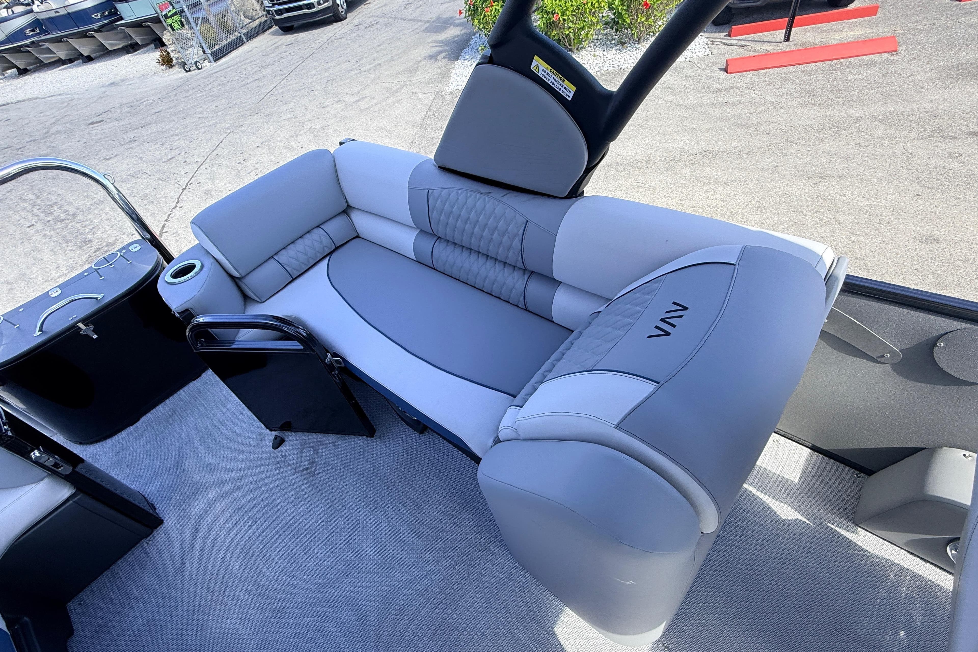 2026 Avalon 2385 Catalina Quad Lounger interior with gray seating and cup holder.