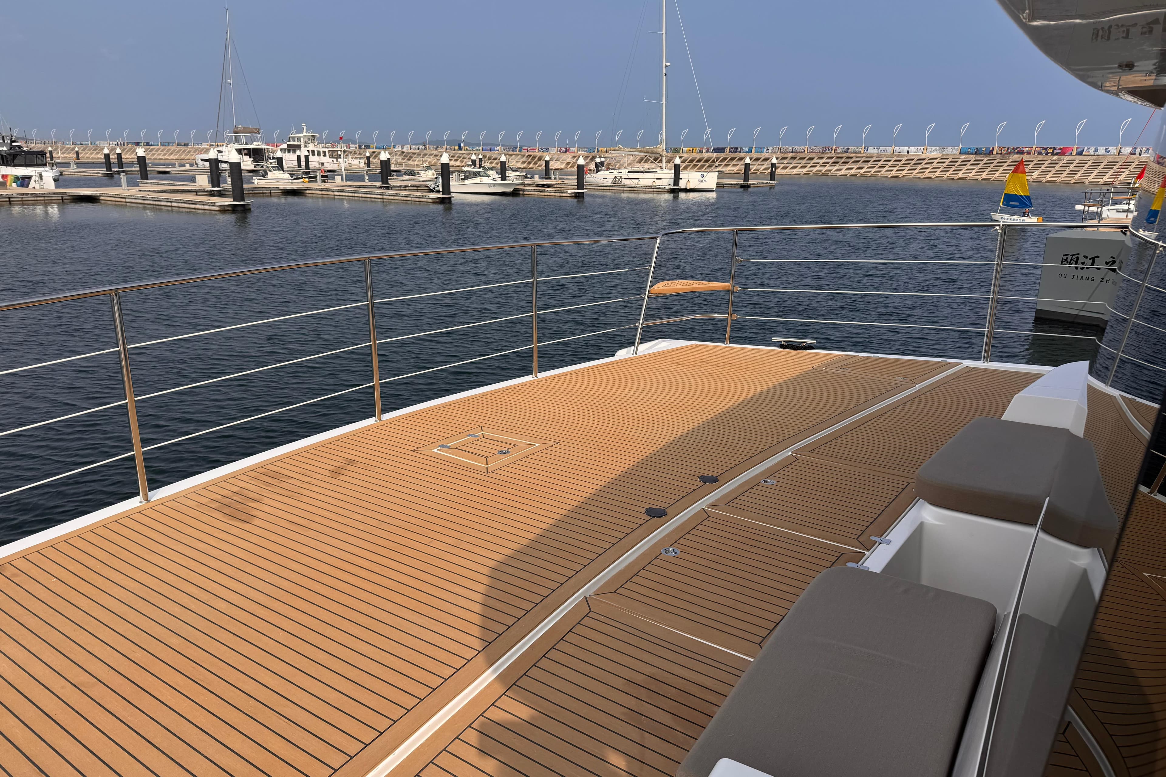 Luxurious deck of 2025 Mazarin 55 EVO II yacht in a serene marina setting.