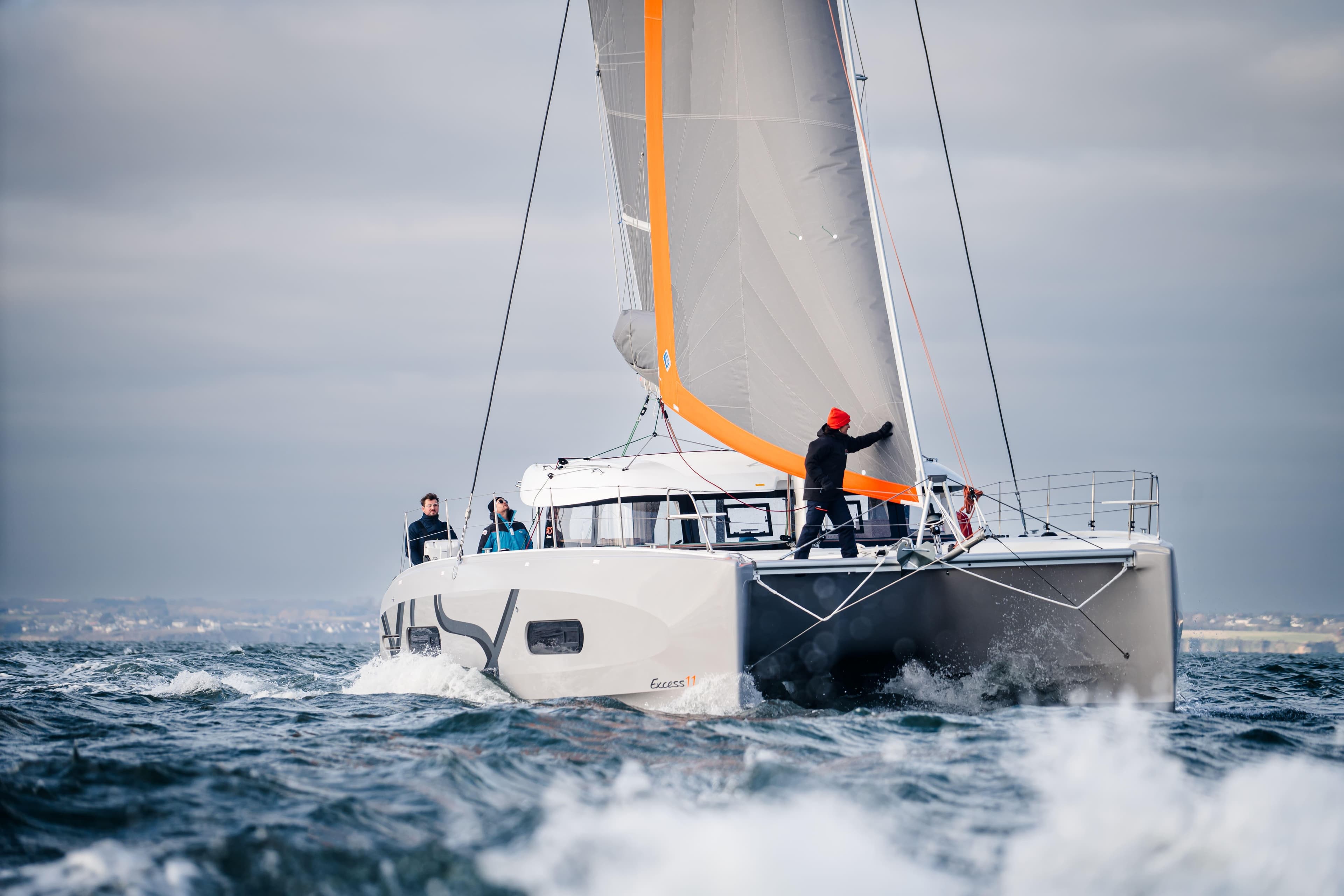 2026 Excess Catamarans EXCESS 11 sailing on open water with crew onboard.