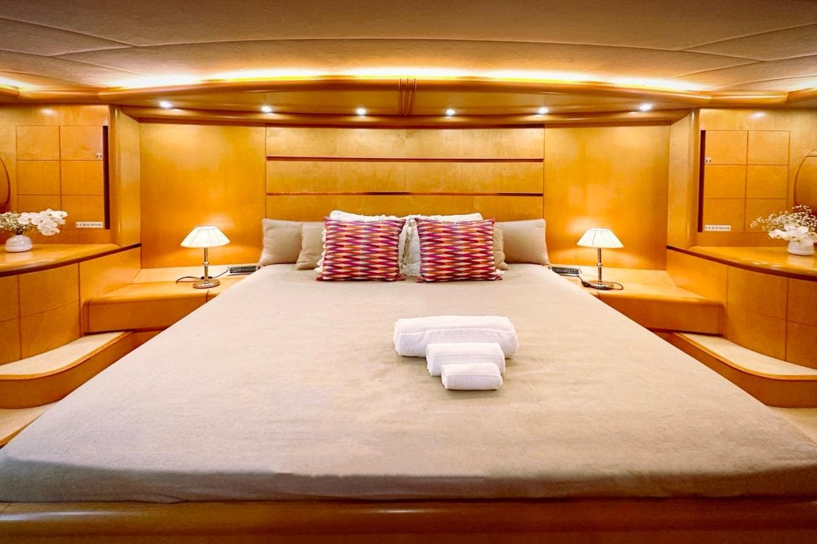 Luxurious bedroom interior of 2000 Maiora 29 DP yacht with elegant lighting and decor.