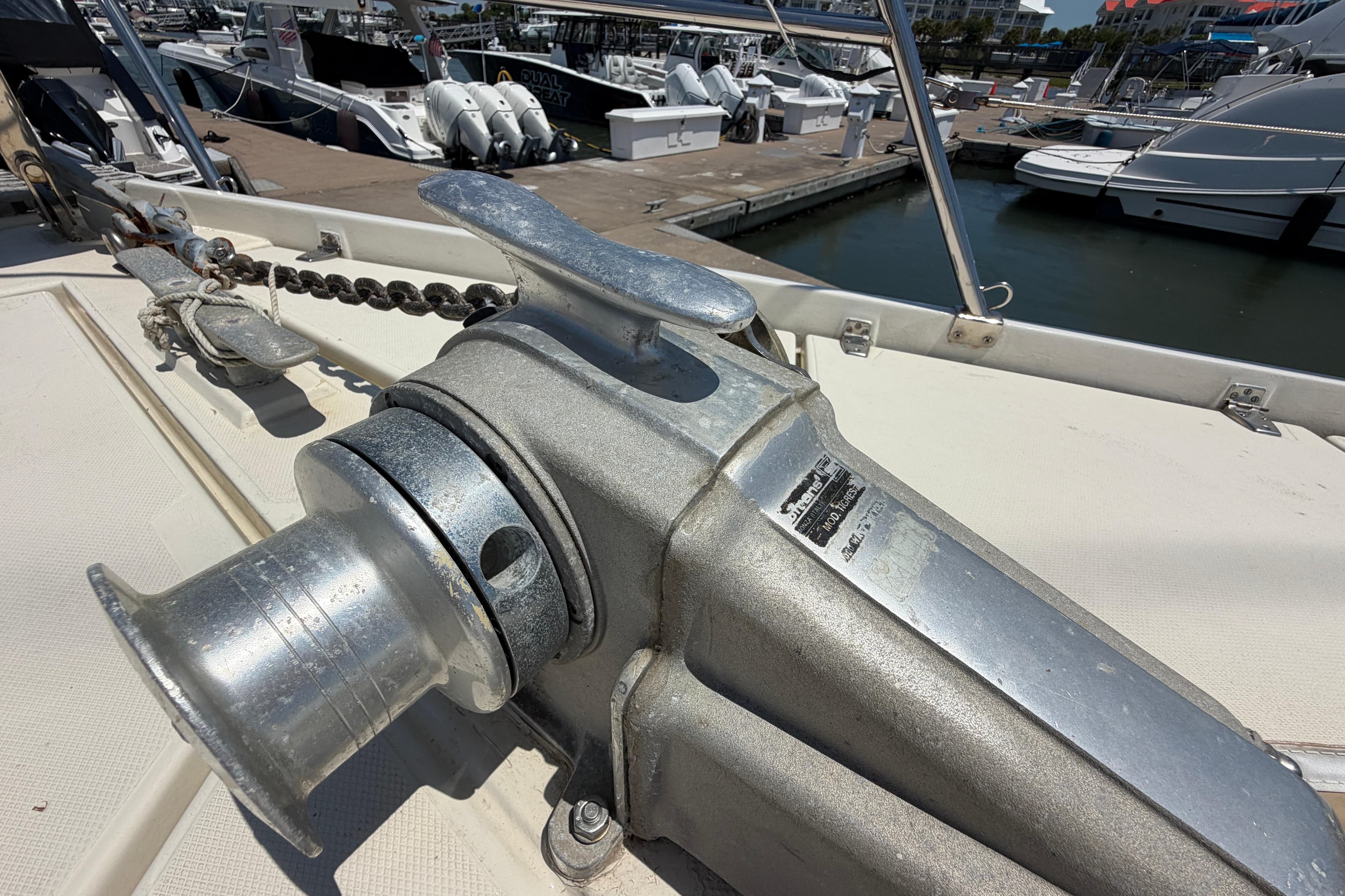 Anchor winch on 1980 Amel Mango 52 yacht at marina dock.