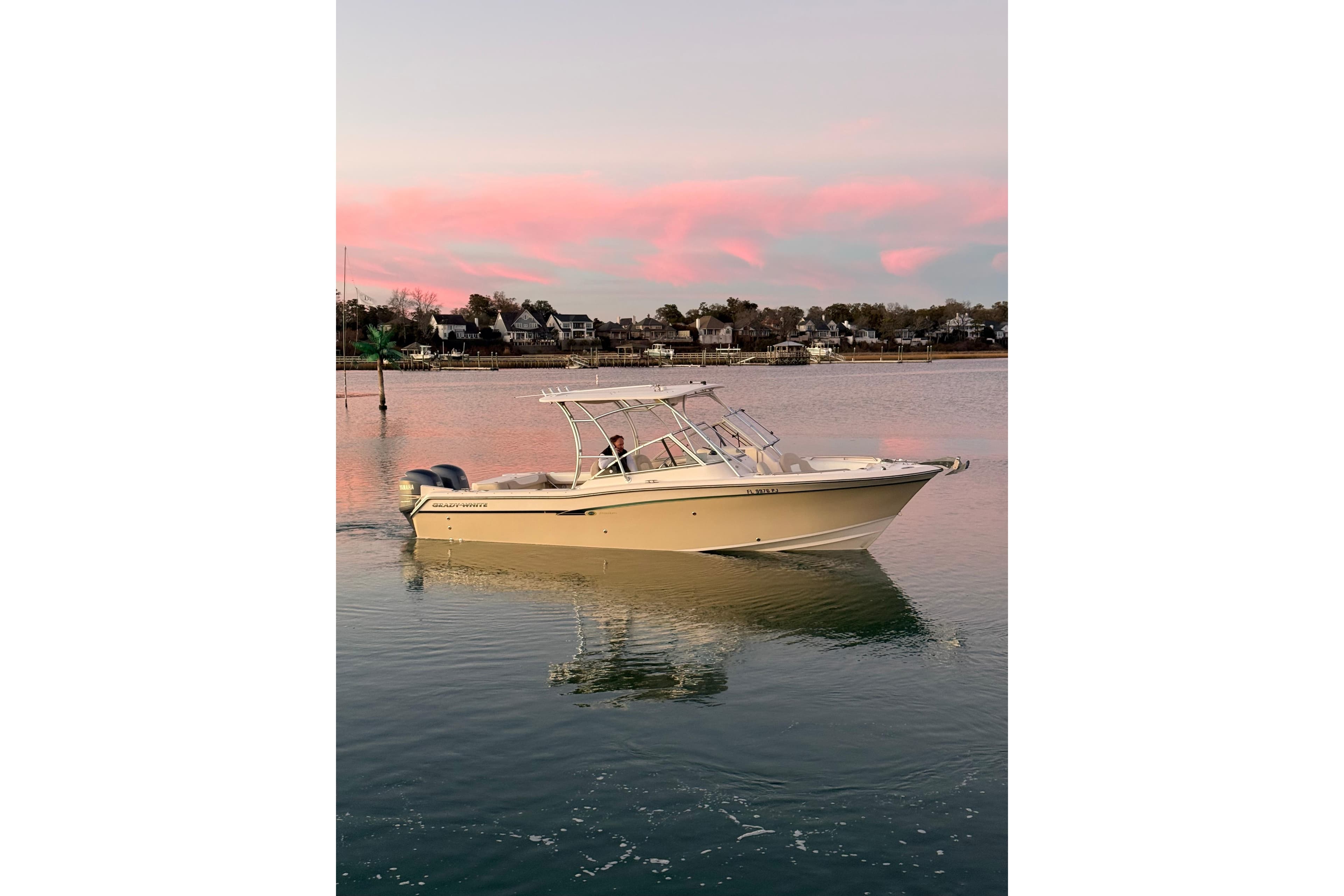 2012 Grady-White Freedom 275 boat on calm water at sunset.