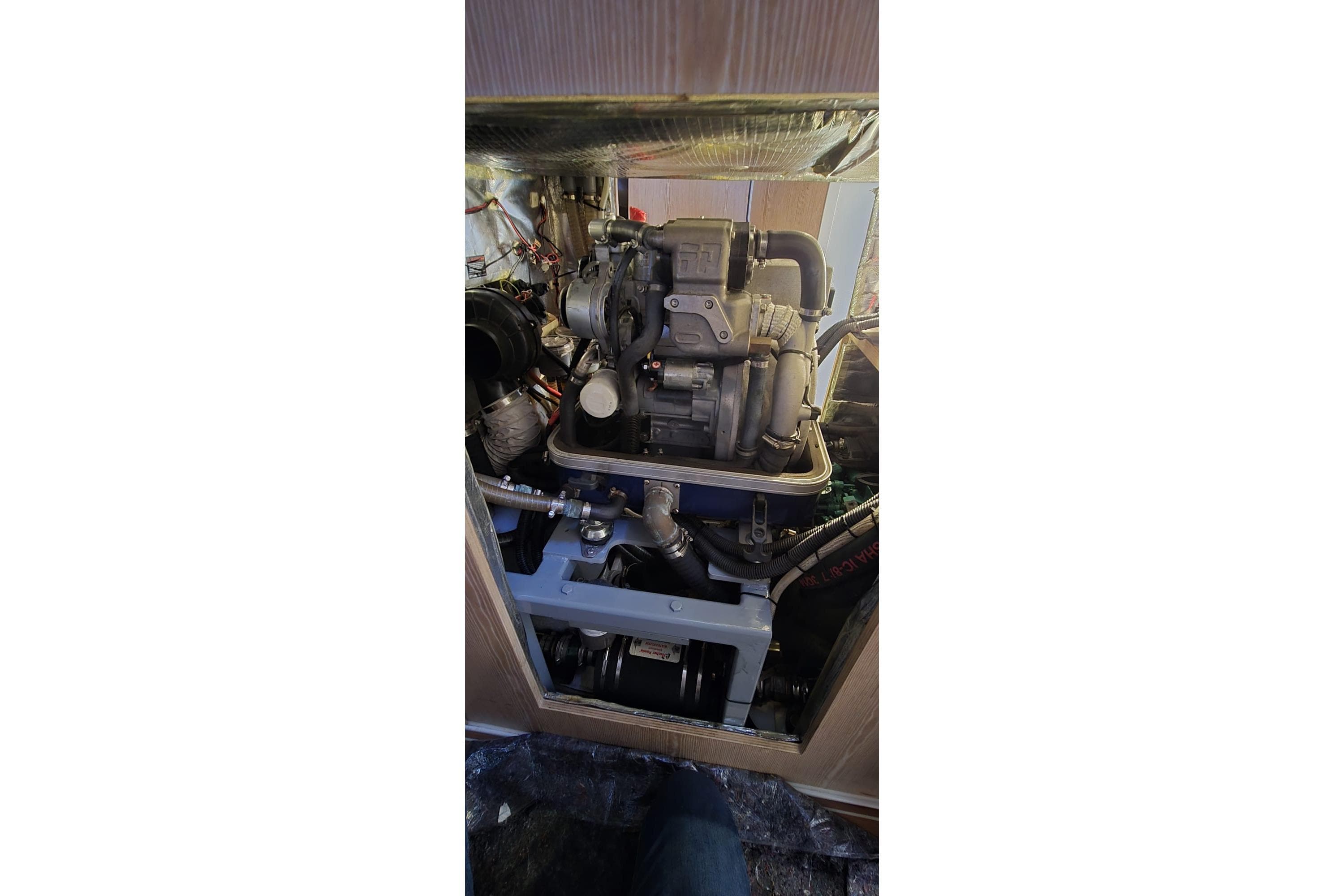 Engine compartment of a 2015 Hanse 575 yacht, showcasing mechanical components.