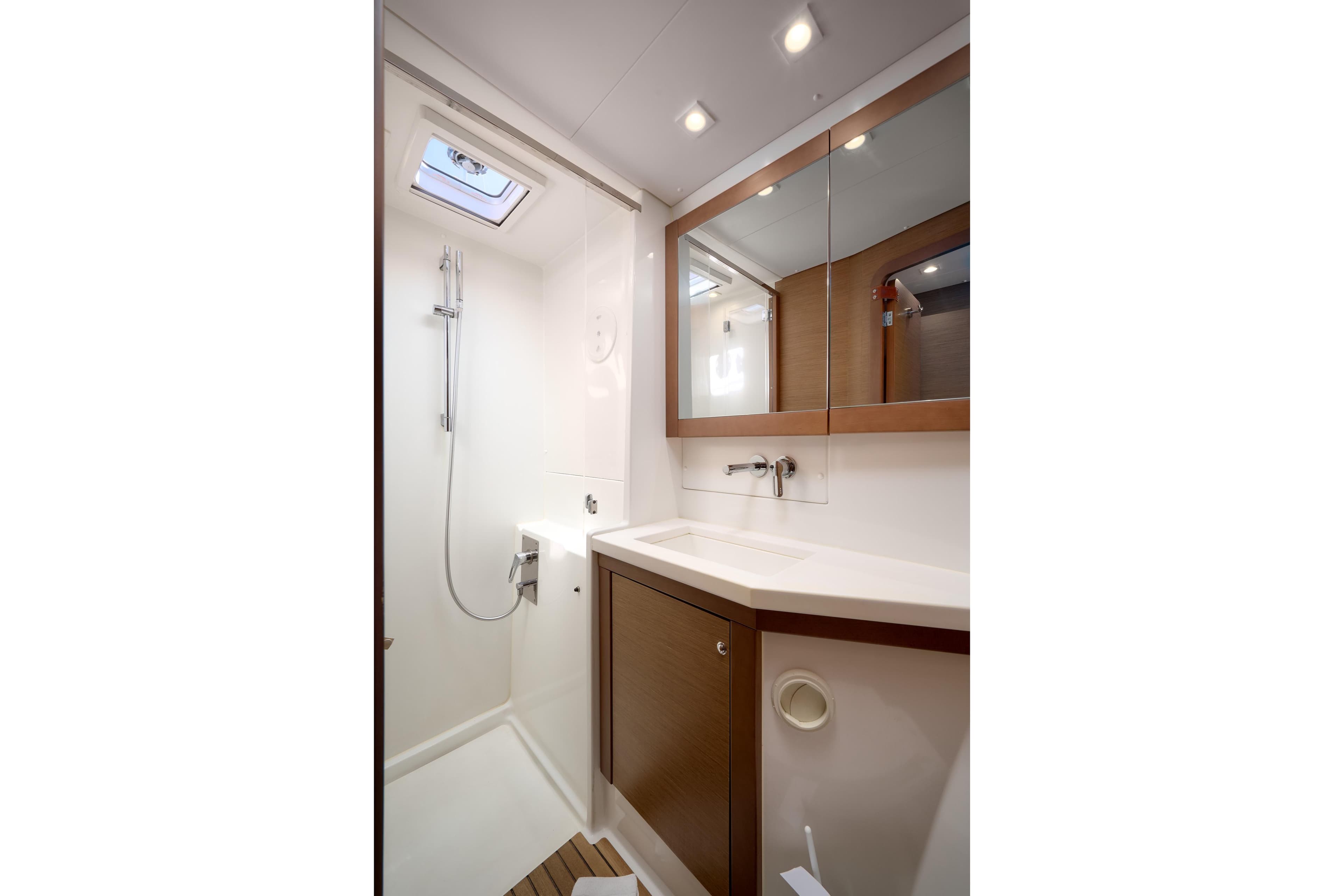 Modern bathroom interior of 2018 Lagoon 450 yacht with shower and vanity.