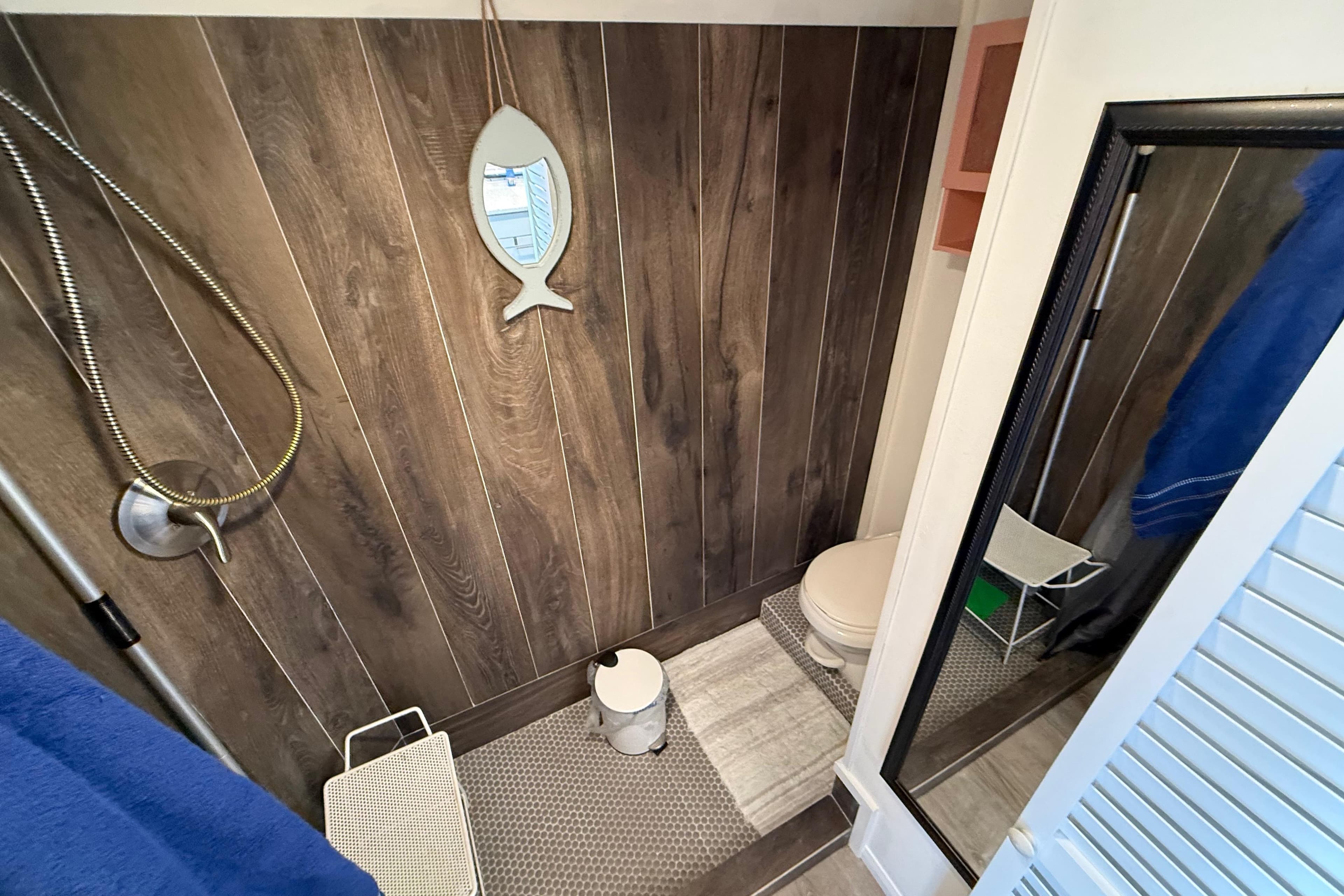 Bathroom interior of 1985 Three Buoys 42 Sport Cruiser HB with wood paneling and nautical decor.