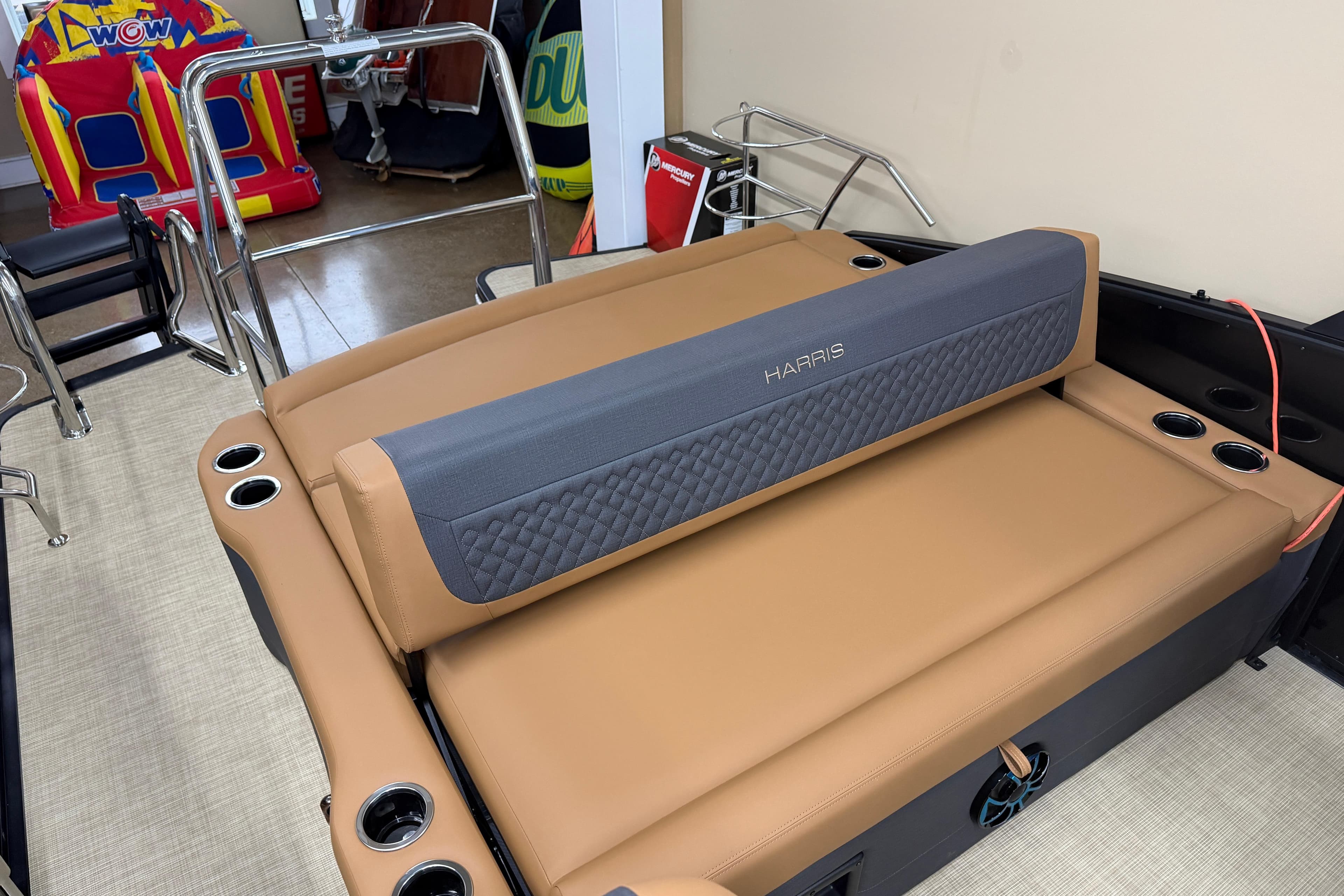 2026 Harris Sunliner 230 boat interior with tan seating and cup holders.