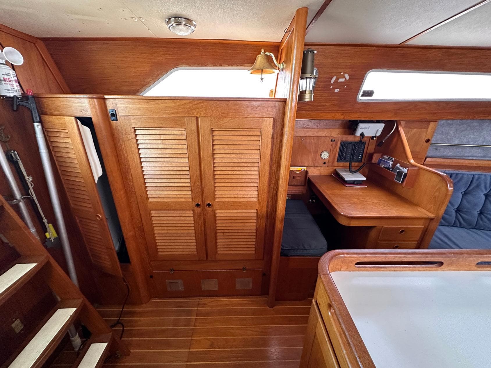 Interior of 1985 Whiting 40 sailboat with wooden cabinetry and navigation station.
