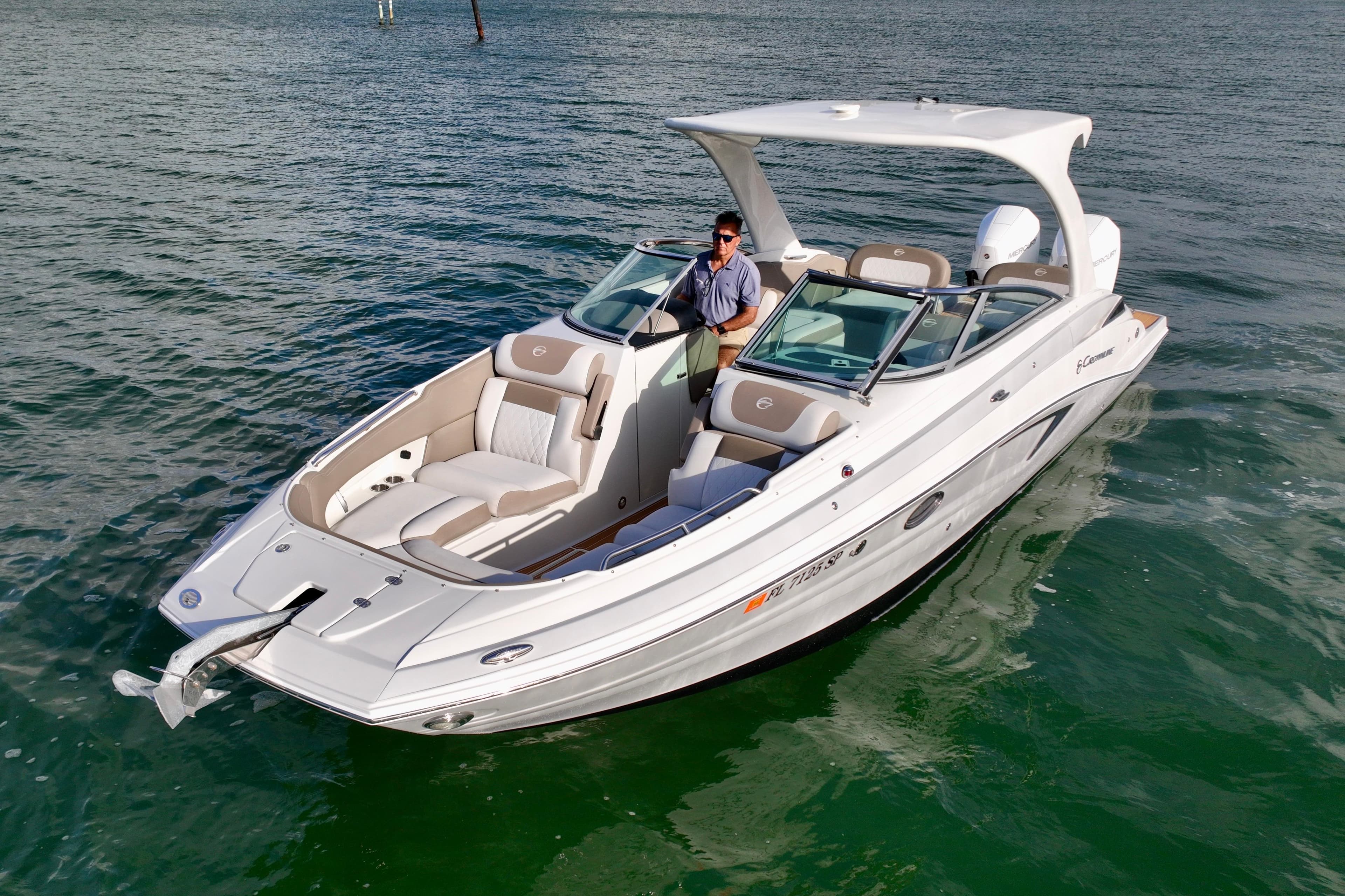 2020 Crownline Eclipse E305 XS boat on water, featuring sleek design and spacious seating.