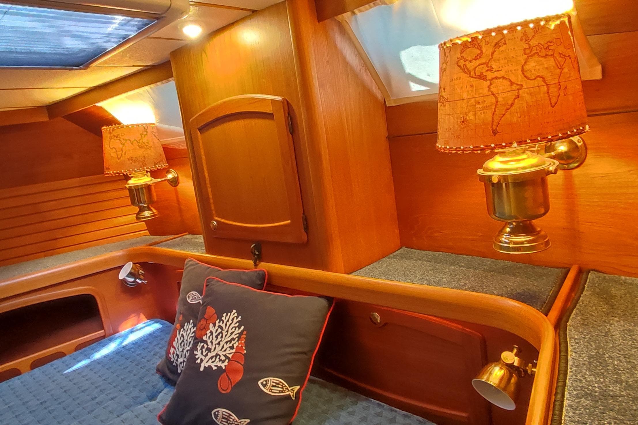 Cozy Nauticat 42 cabin interior with nautical-themed decor and warm lighting, 1997 model.