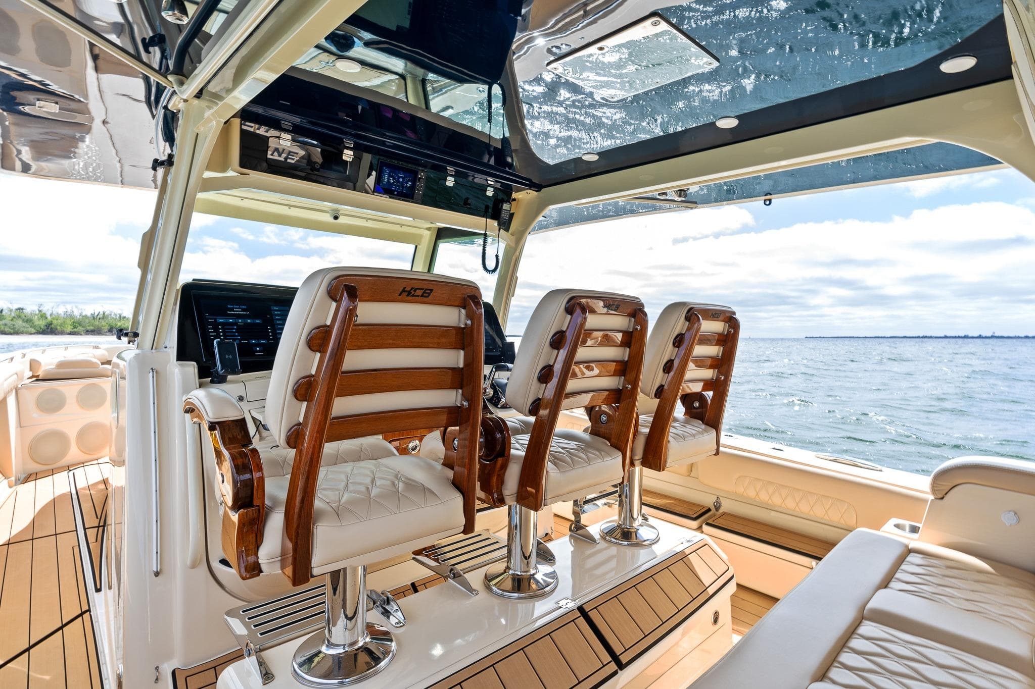 Luxurious interior of 2023 HCB 53 Suenos RXV boat with elegant seating and ocean view.